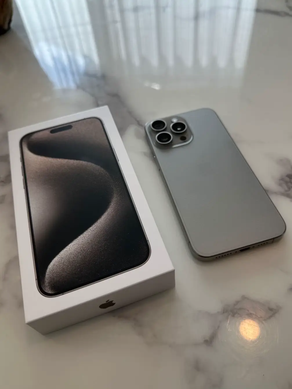 Unboxing iPhone 15 Pro Max box in Natural Titanium color - (Mention  @zana_qaradaghy on Instagram while use this photo) Follow on Instagram  @zana_qaradaghy · Free Stock Photo