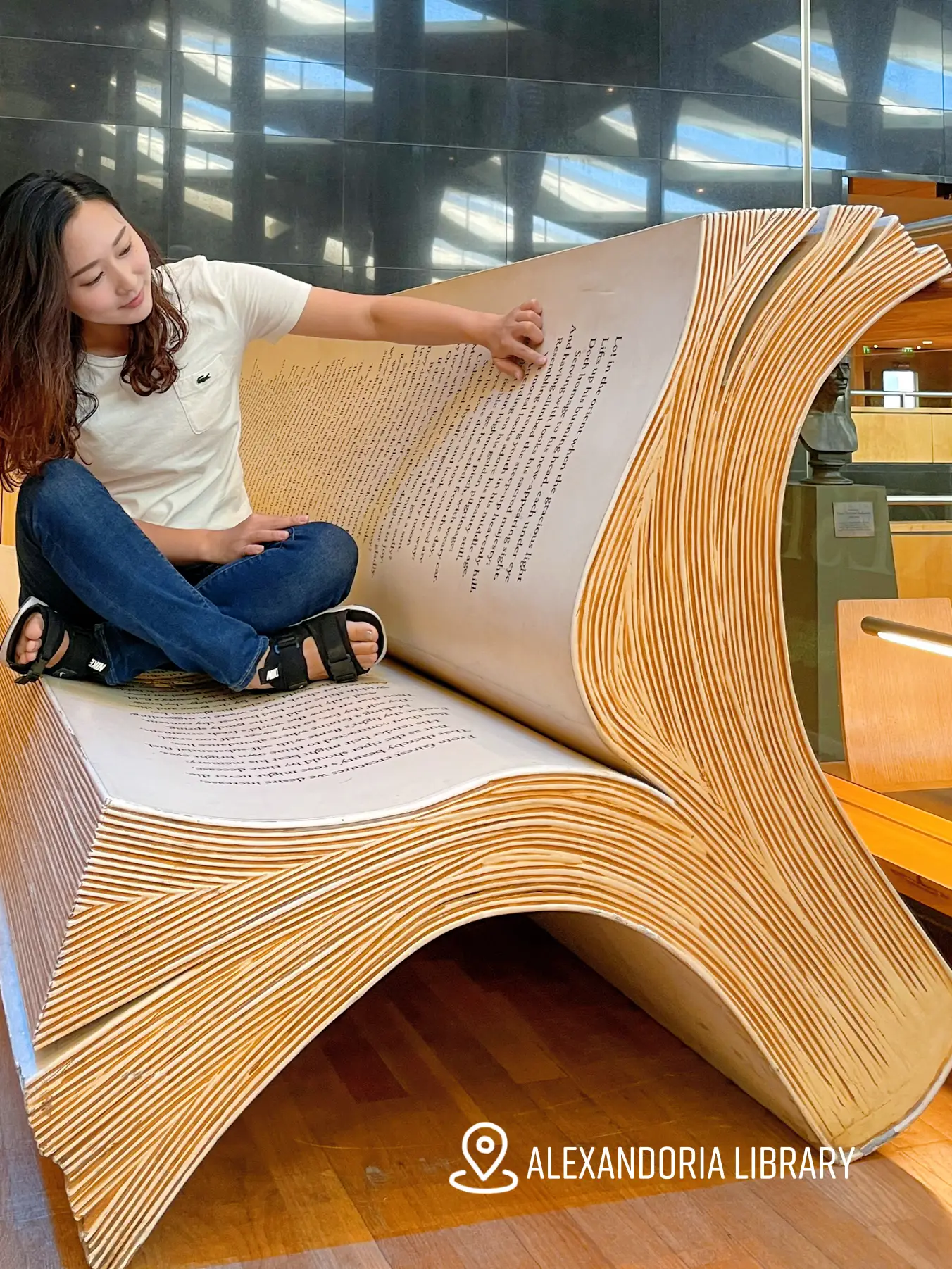 Reading a large book at the library of alexandria gallery posted by