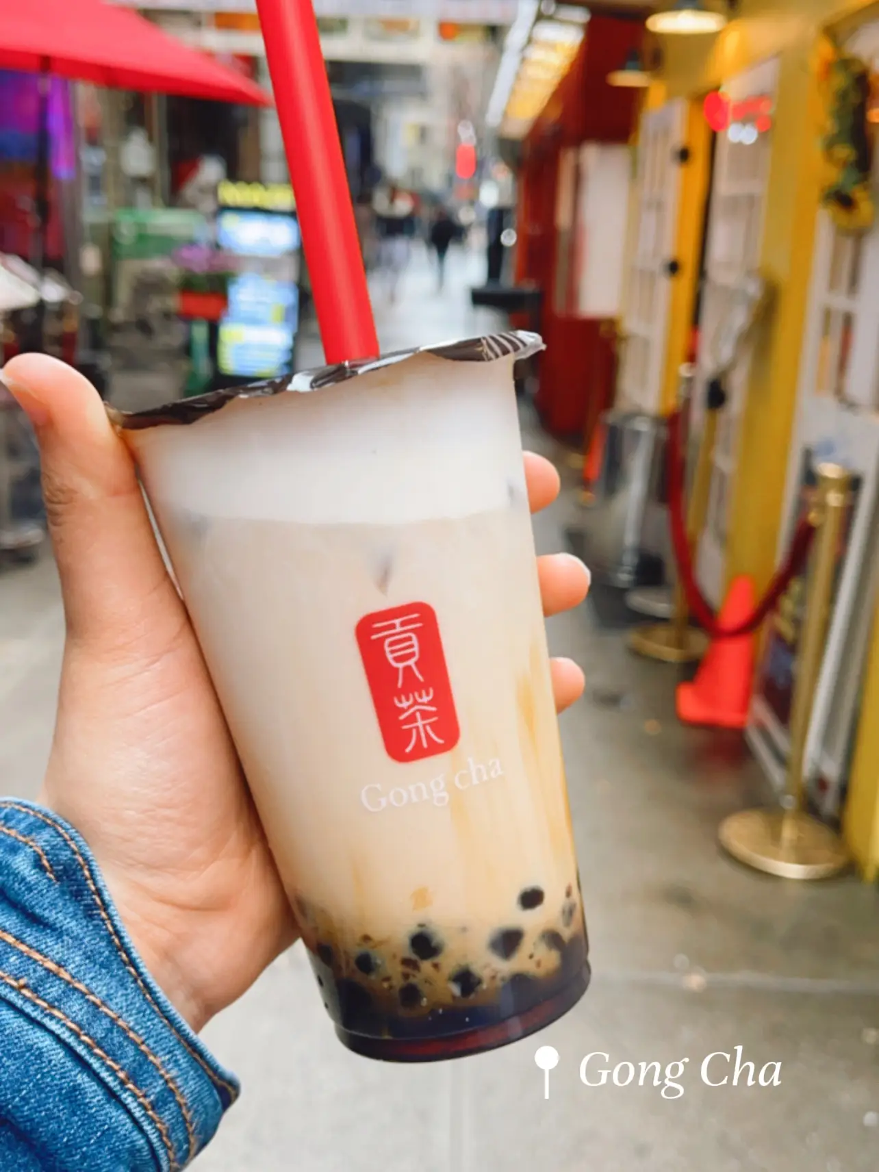  A person is holding a Gong Cha cup.