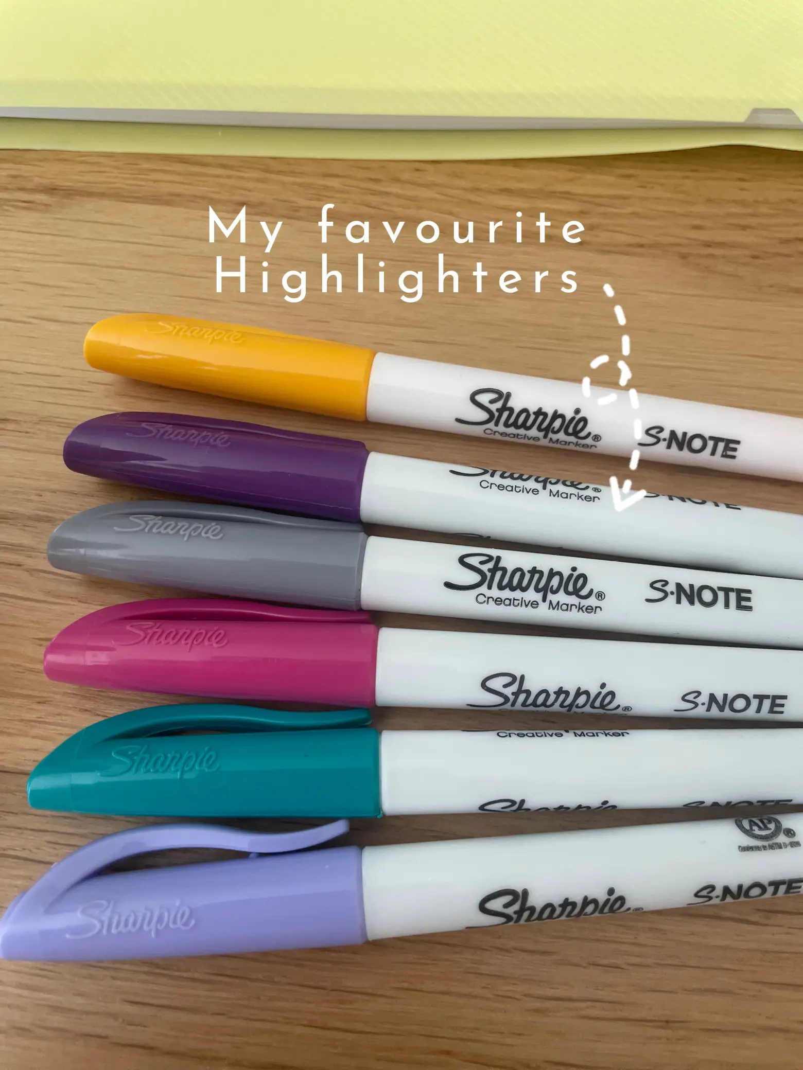  A row of seven different colored Sharpie Highlighters.