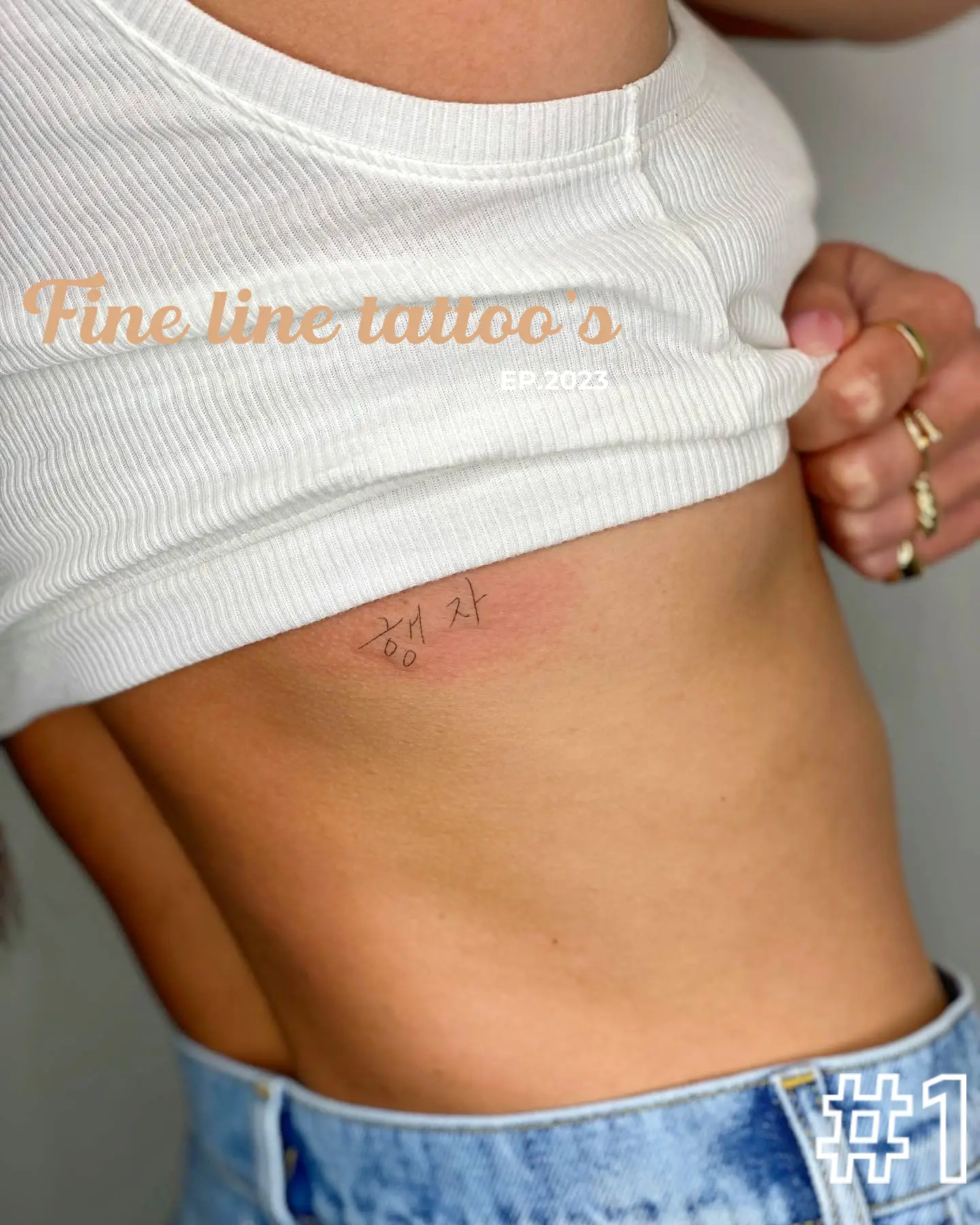 Fine line leaves tattoo located on the rib.