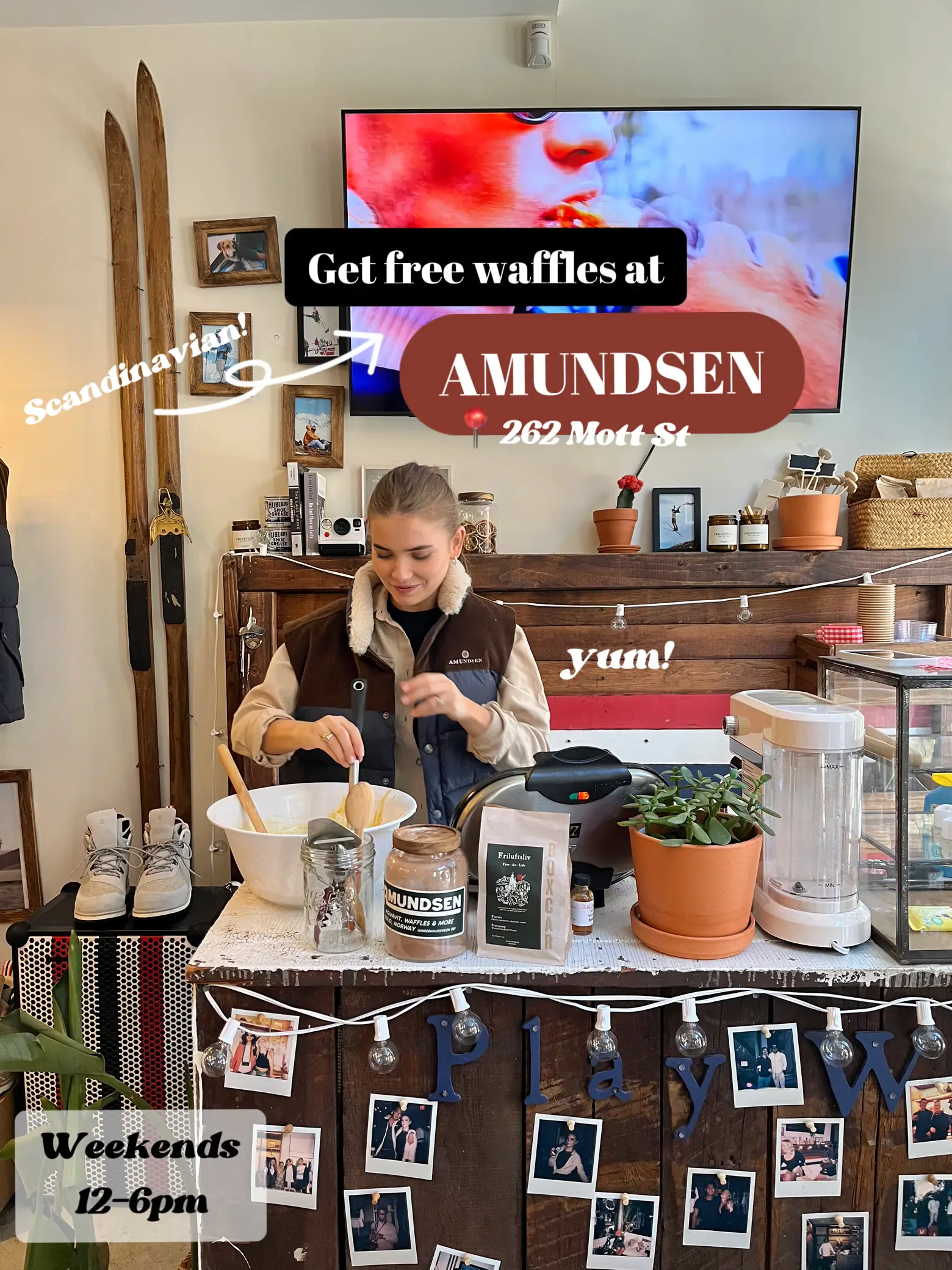  A woman is standing behind a counter at Scandinay AMUNDSEN, making waffles.