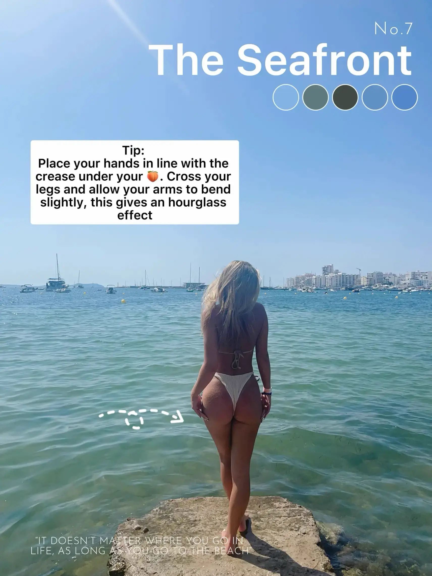  A woman in a bikini is standing on a rock near the water.