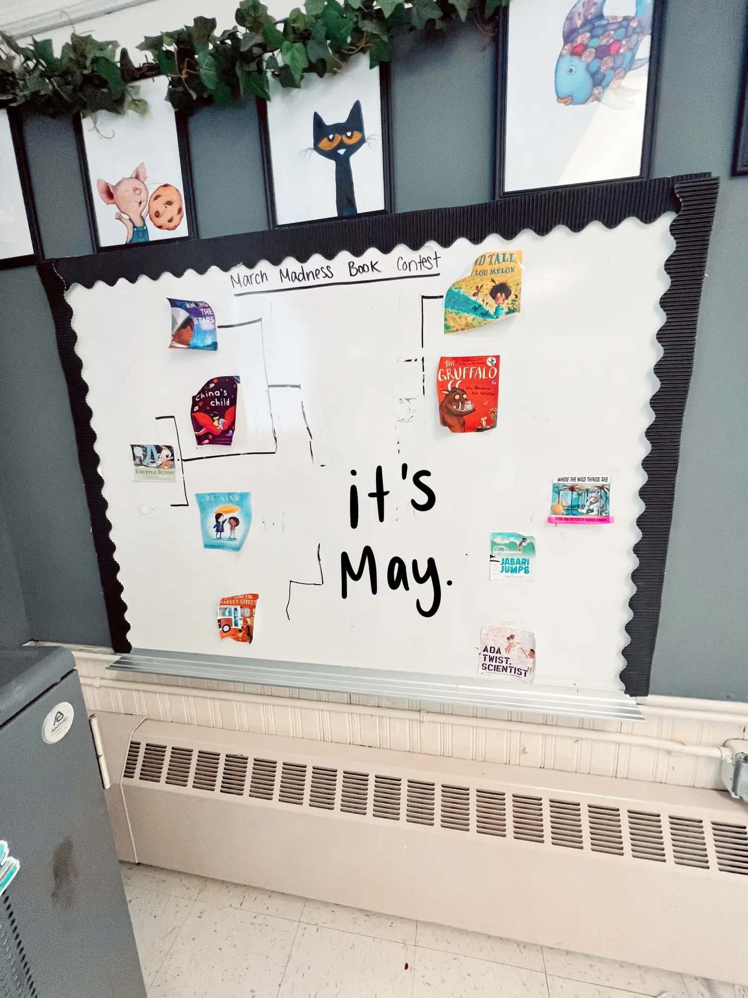  A bulletin board with a calendar on it that says "It's May Where the wild things are".