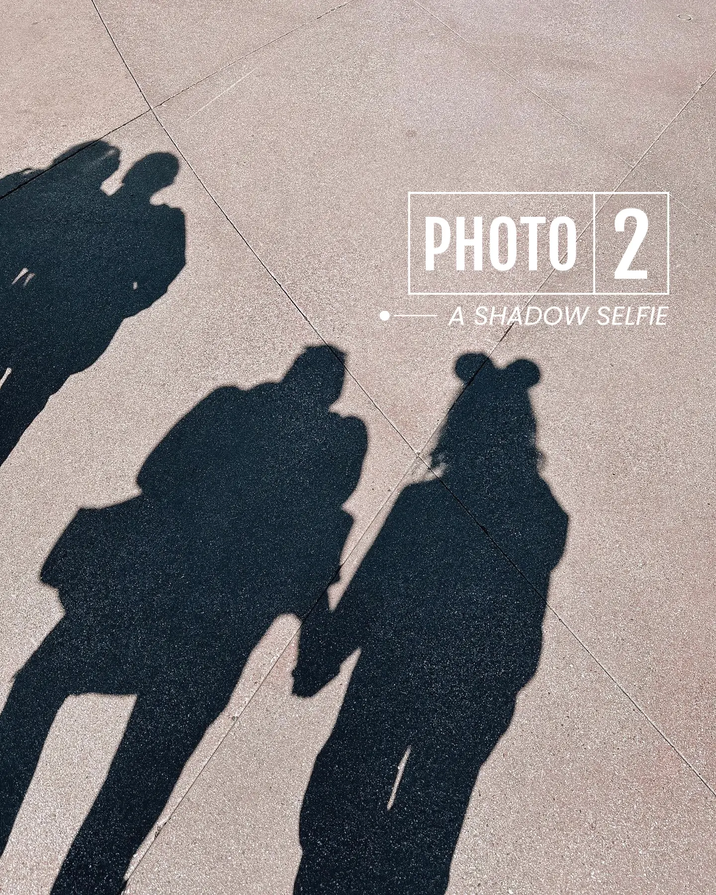  Three people are walking on a sidewalk, and their shadows are cast on the wall. The shadows are labeled with the words "PHOTO 2" and "A SHADOW SELFIE".