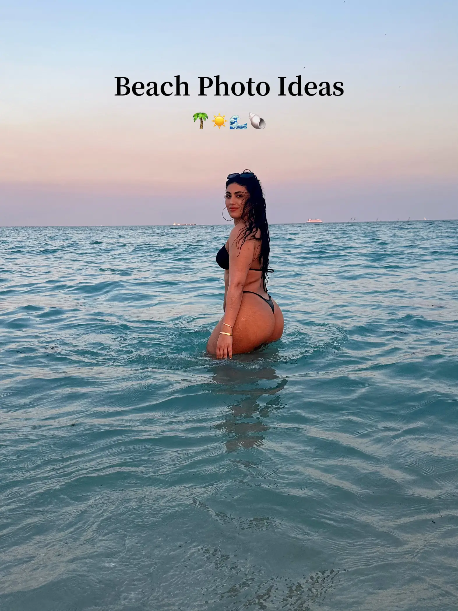  A woman in a bikini is standing in the water.