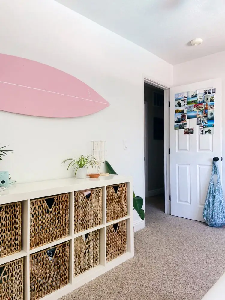  A room with a white door and a picture of the ocean on the wall.
