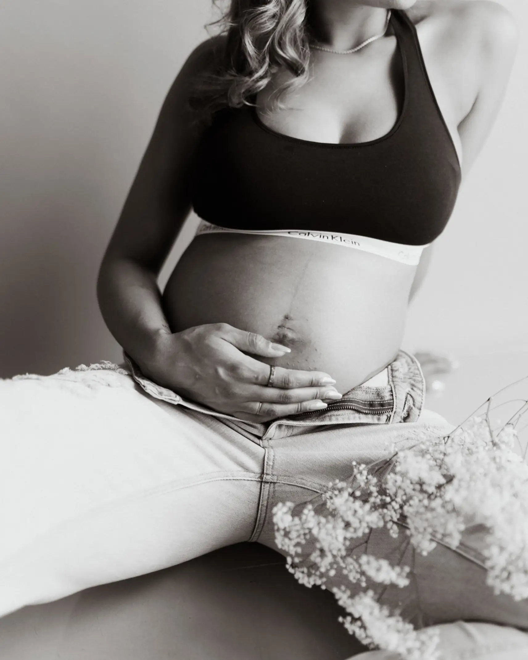 Pregnant Girl In Bra And Pants Sitting On Bed #2 Photograph by