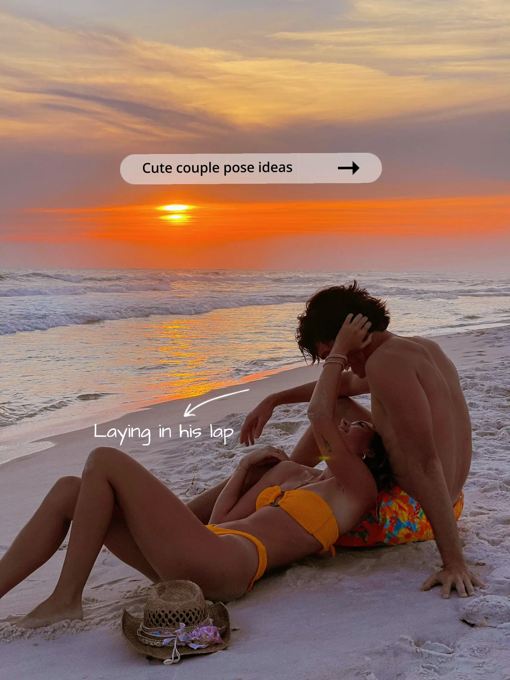  A man and a woman are laying on a beach, with the man holding the woman in his lap. The sun is setting in the background, creating a beautiful and romantic atmosphere.