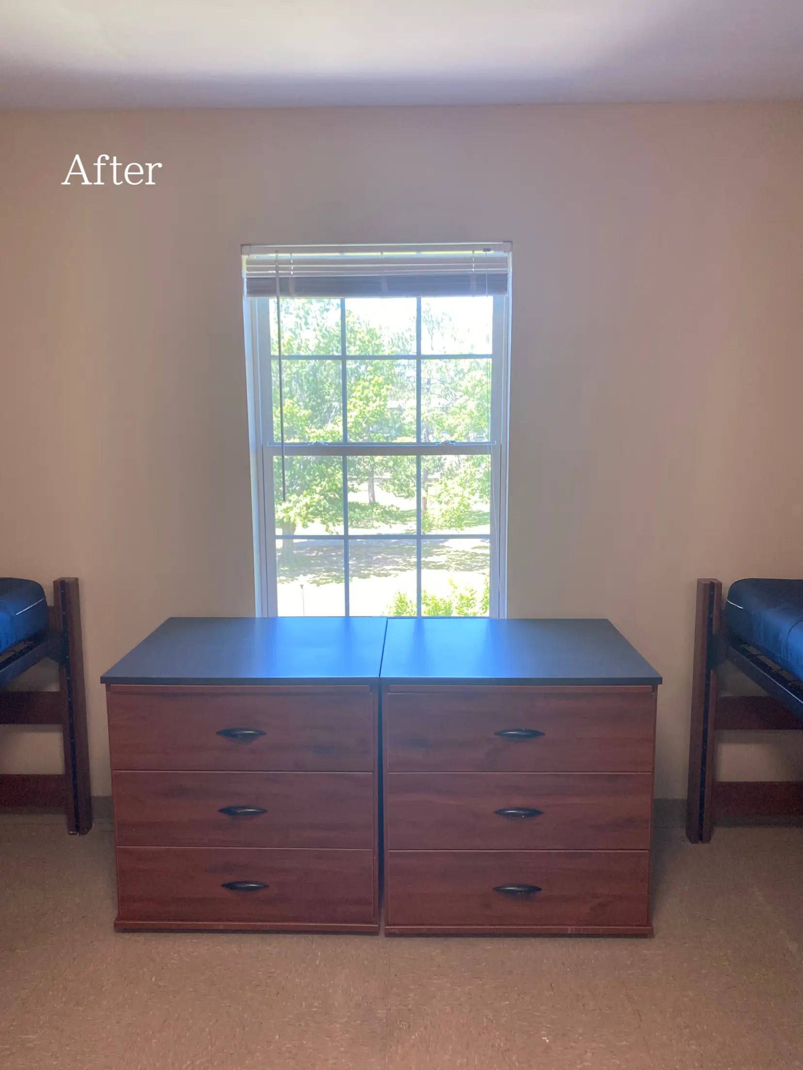  A bedroom with a bed and a desk. The desk has a drawer and a chair. The room is painted blue and has a window.