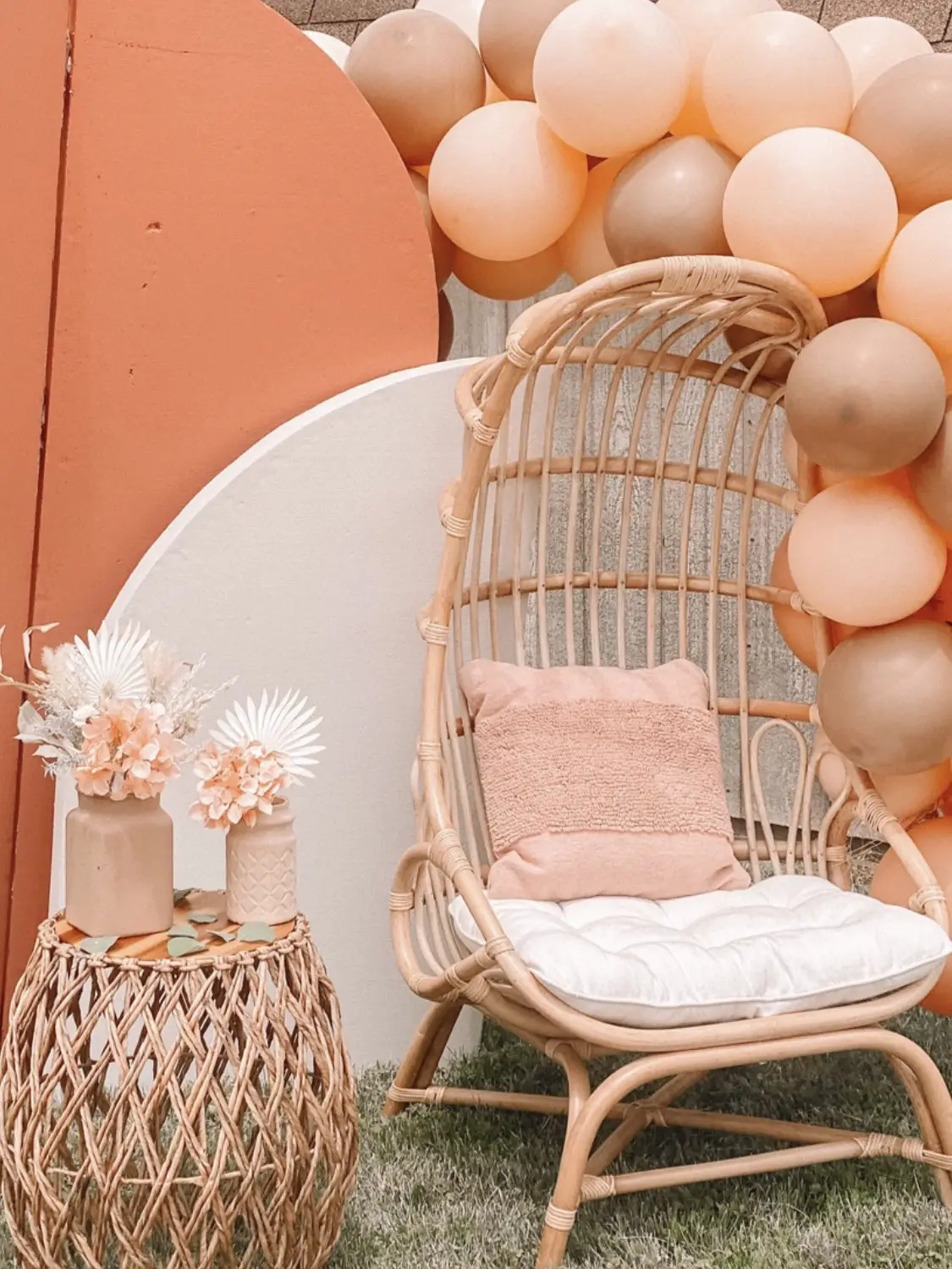 Maternity portrait of a pregnant lady wearing a yellow dress in a wicker  peacock chair