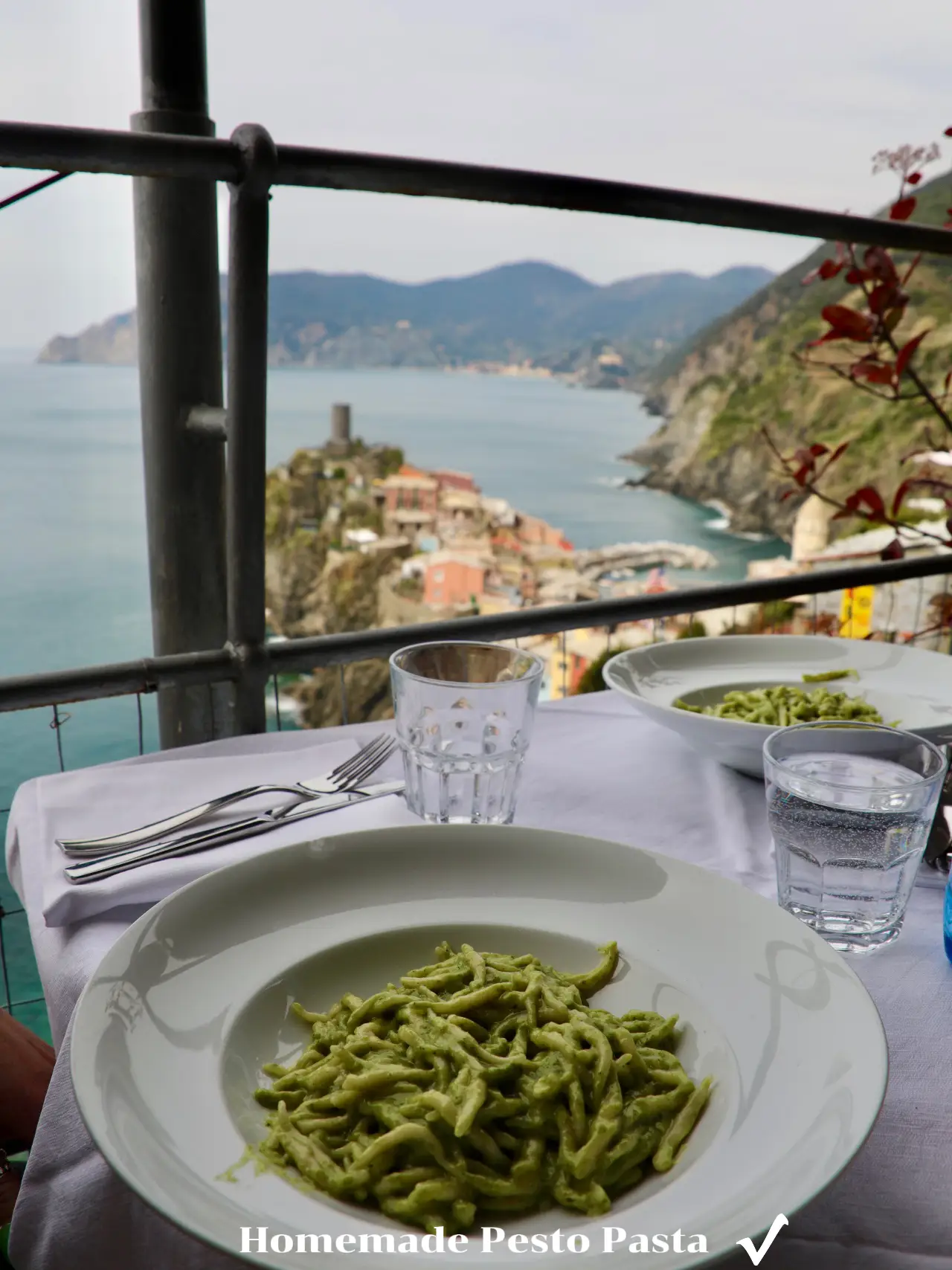  A plate of pasta with a sauce of pesto.