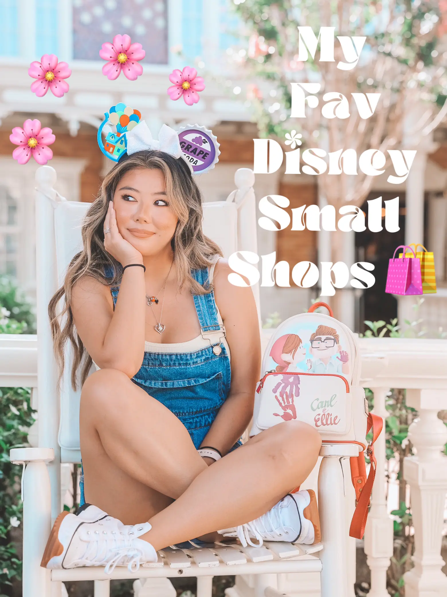  A woman is sitting on a bench with a sign that says "My Fav Disney Small Shops."