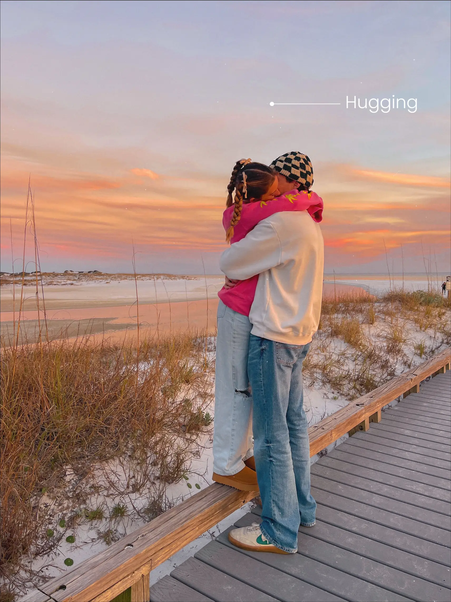 Three people are hugging each other on a boardwalk.