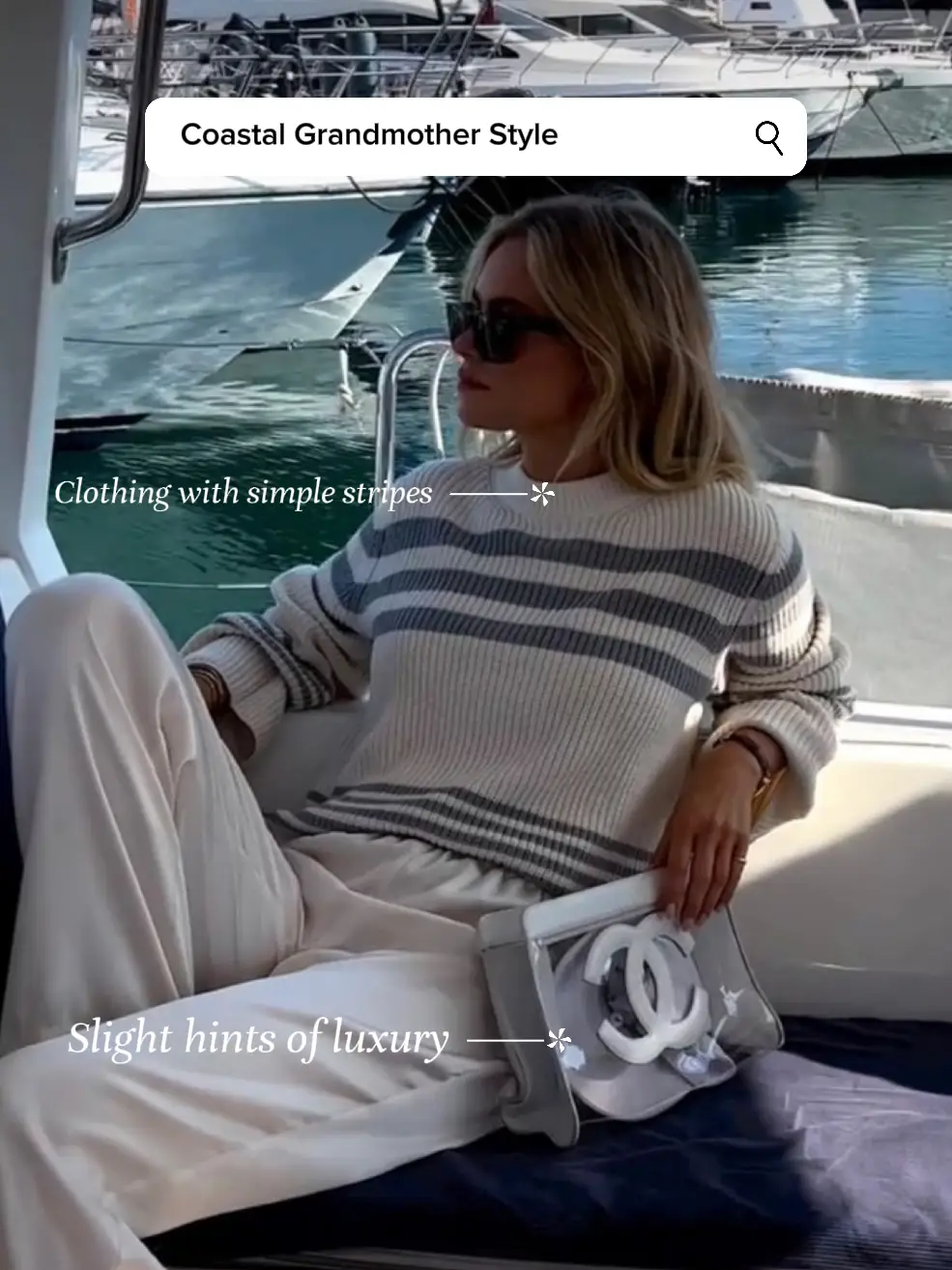  A woman wearing a white striped sweater and white pants is sitting on a boat.
