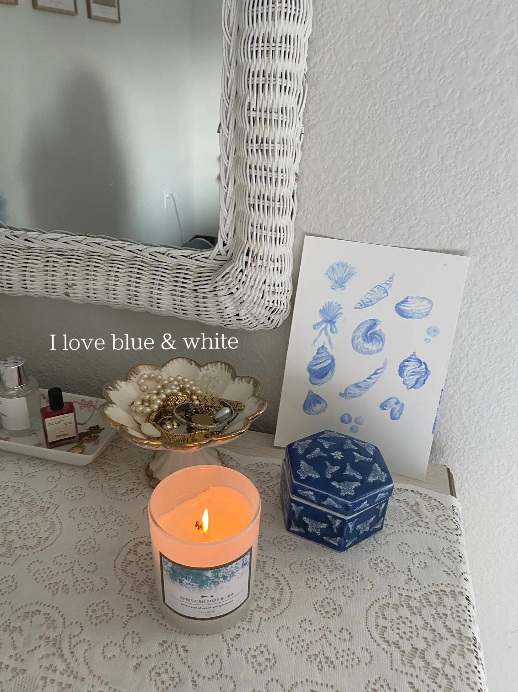  A table with a candle and a picture of a flower.