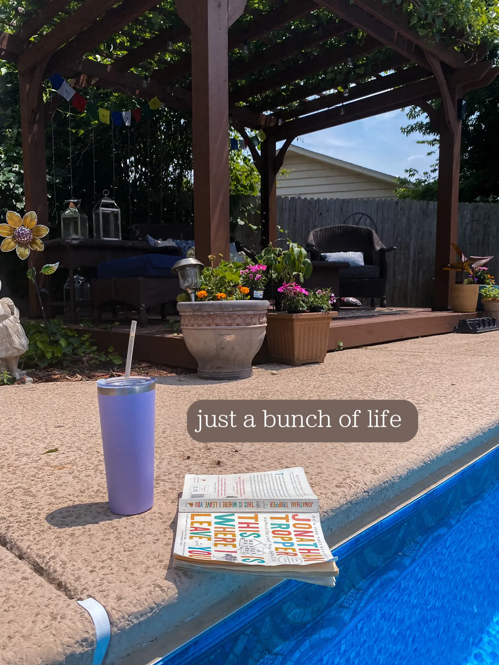  A book of puzzles is laying on a blanket on a patio.
