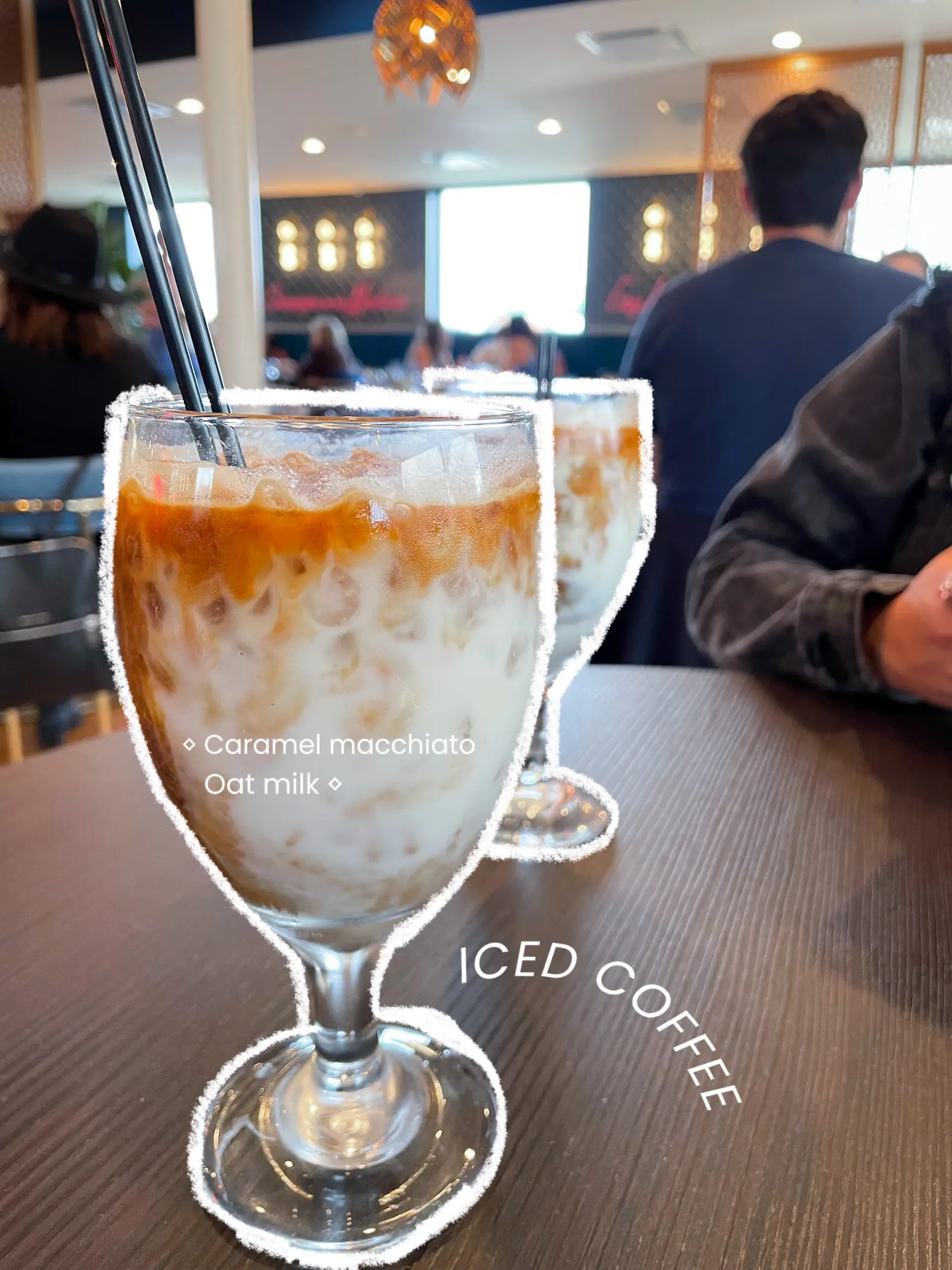  A glass of iced coffee with a spoon in it.