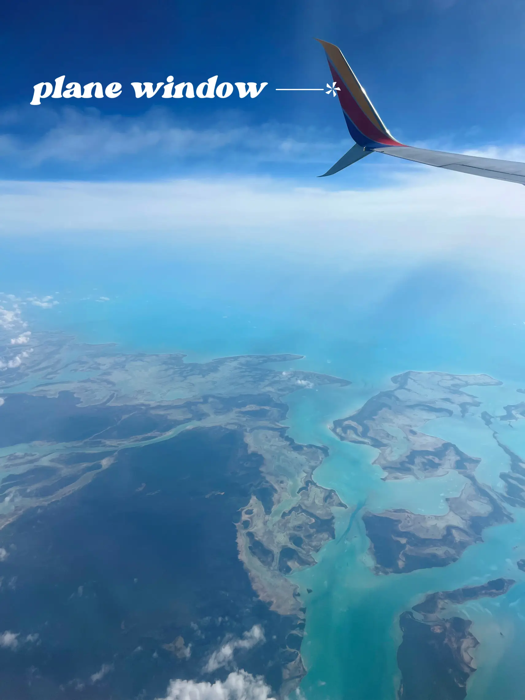  An airplane is flying in the air with a plane window.