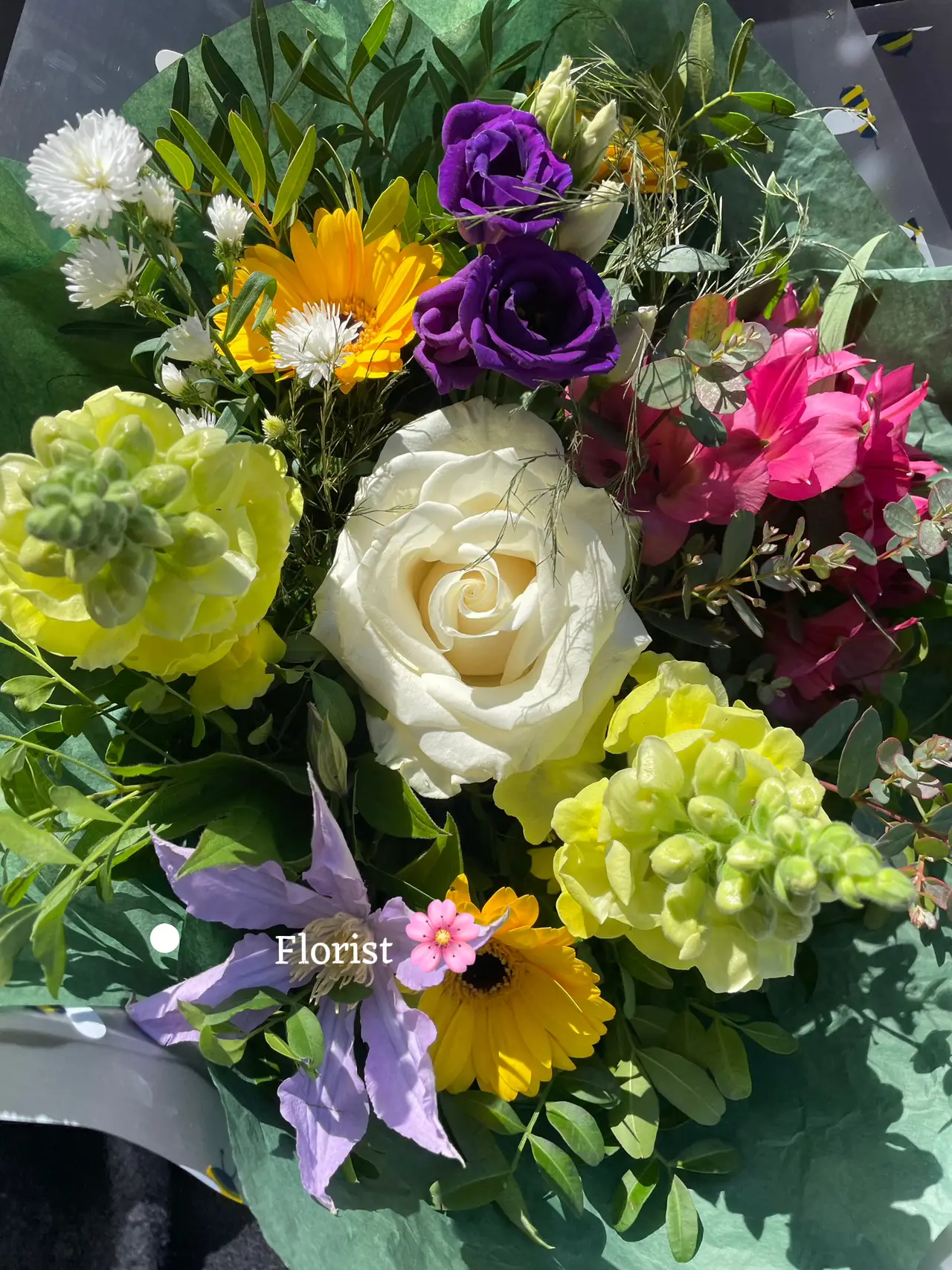  A bouquet of flowers with a card that says "Flowerist".