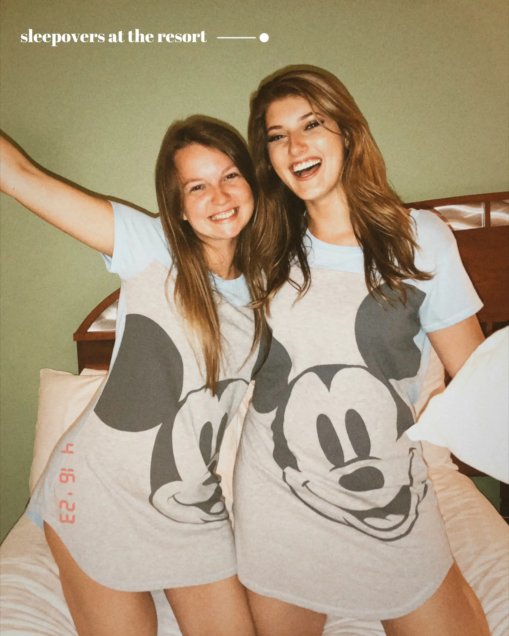  Two women wearing Mickey Mouse shirts are standing next to each other.