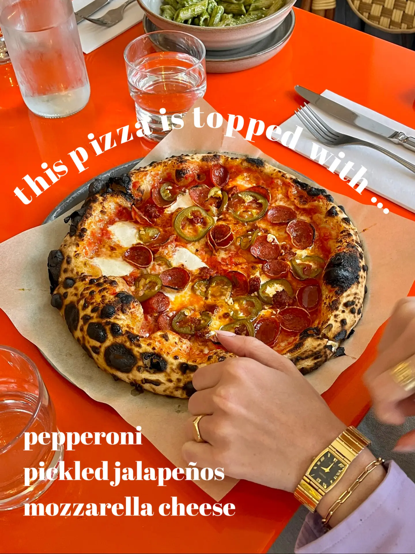  A pizza with pepperoni, jalapeños, mozzarella cheese and tomato sauce.