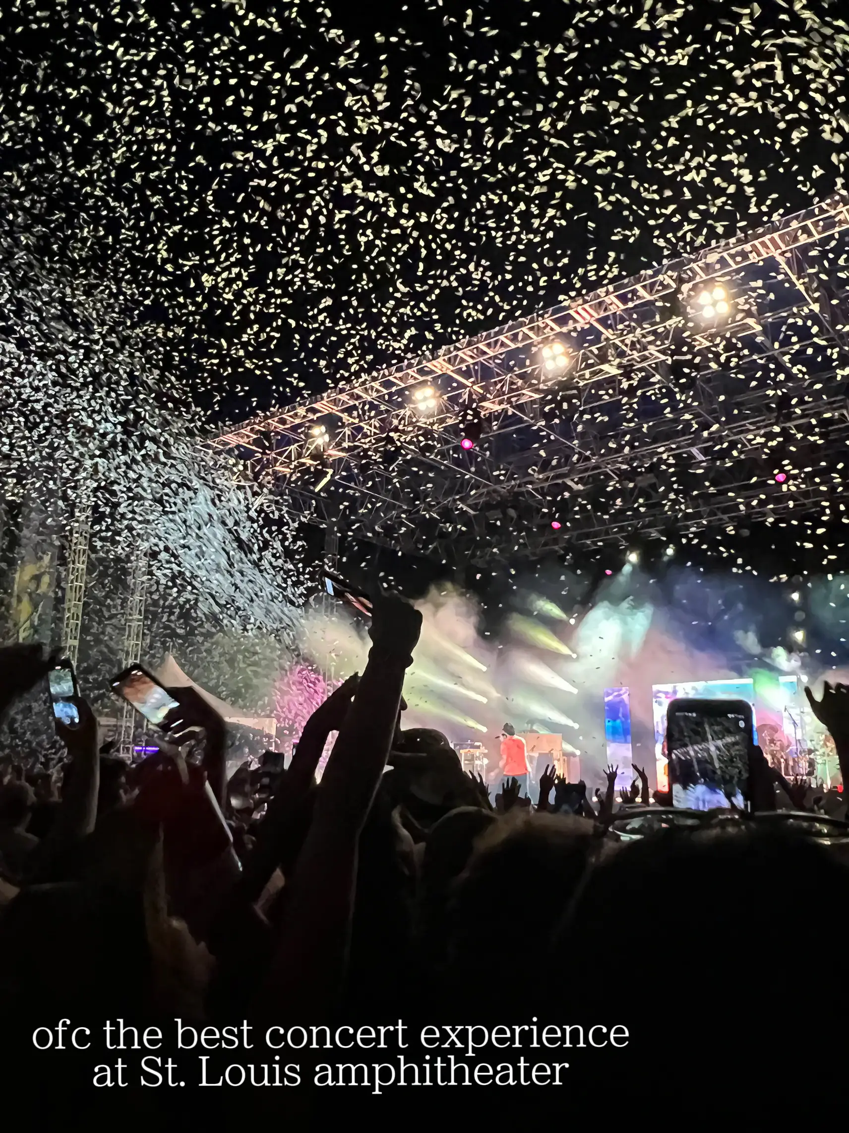  A large crowd of people are gathered in an arena, watching a concert. The atmosphere is lively and energetic, with the audience members cheering and enjoying the performance. The image is