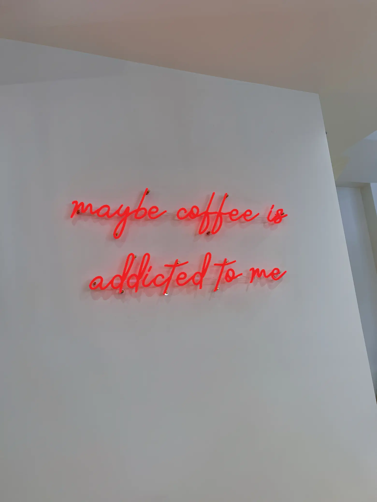  A neon sign that says "caffee is addicted to me".