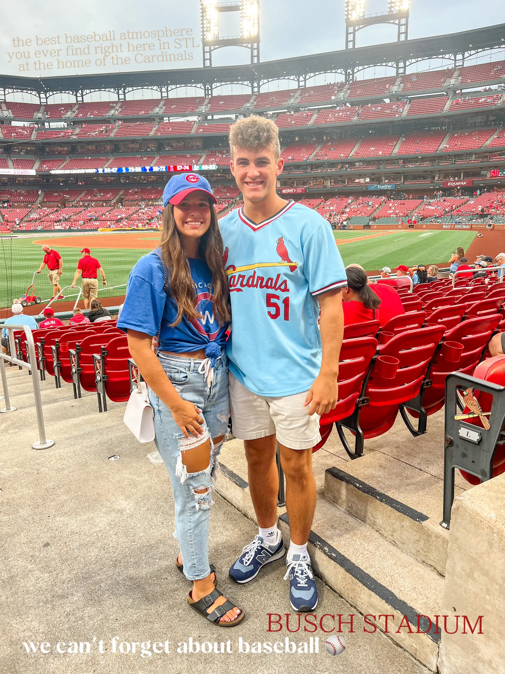  A man and a woman are posing for a picture at a baseball game at the Busch Stadium.