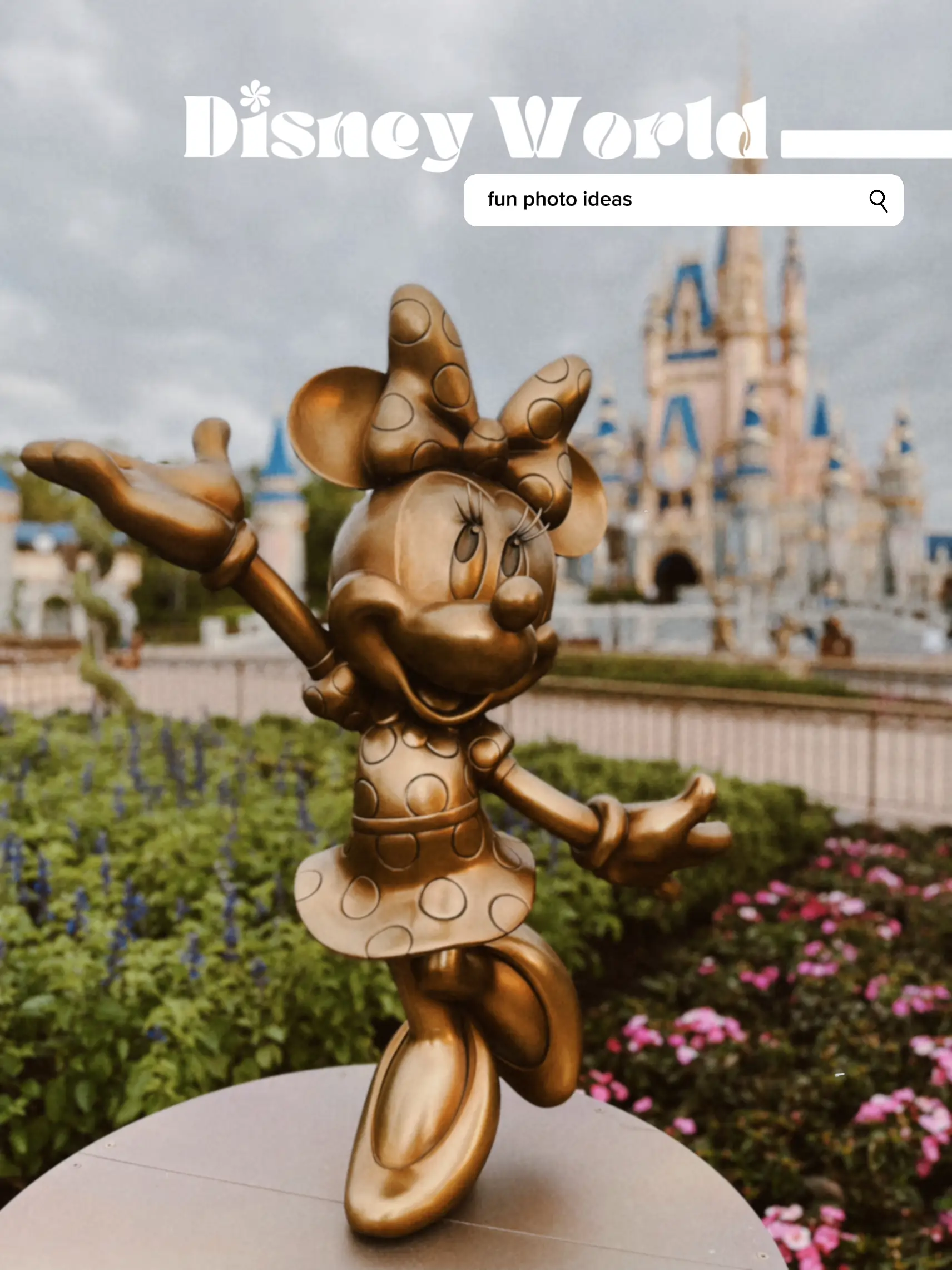  A statue of Mickey Mouse in front of a castle.