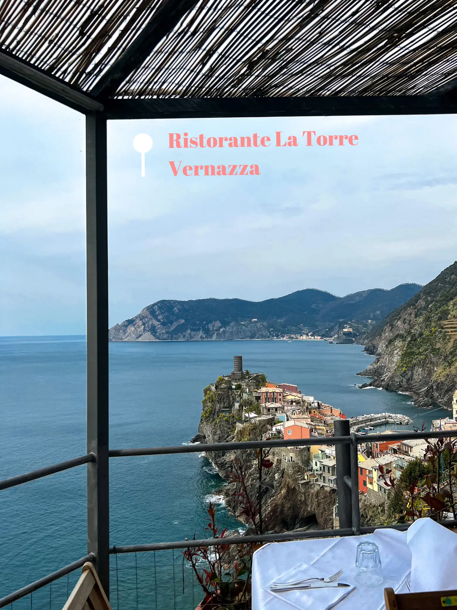  A view of the ocean with a hillside in the background. The words "Vernazza" are displayed above the view.