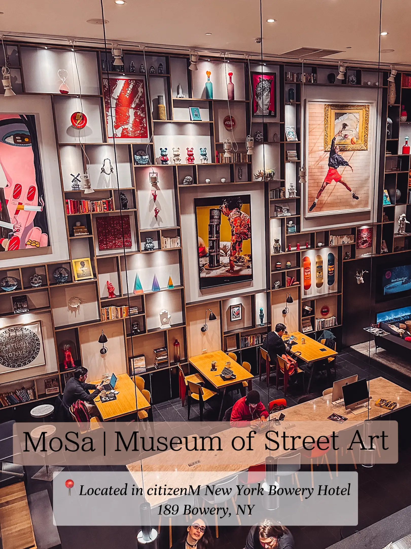  A museum of street art is displayed in a room with a table and chairs.