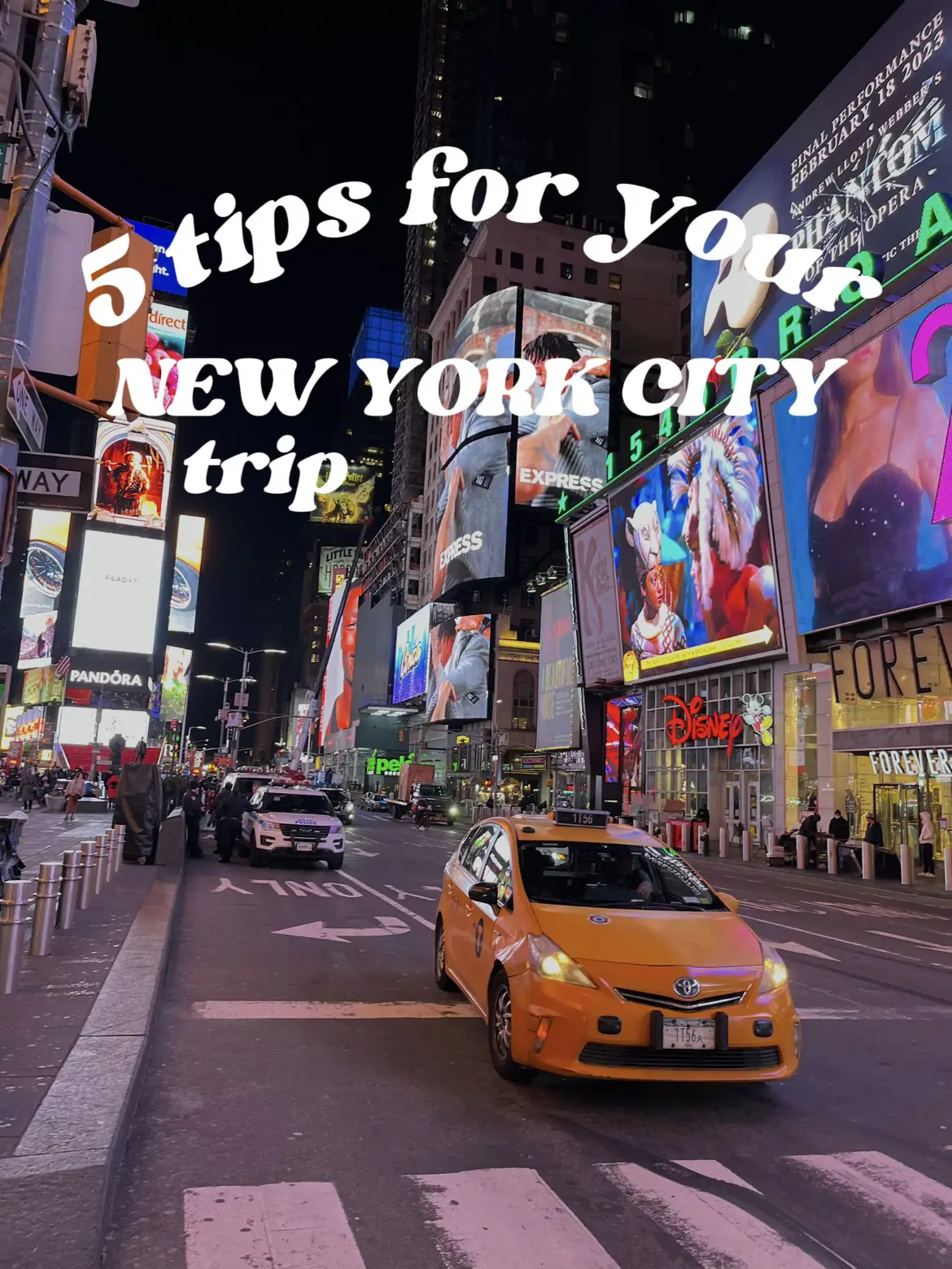  A blue car is driving down a busy city street with a sign that says "5 tips for New York City". The car is