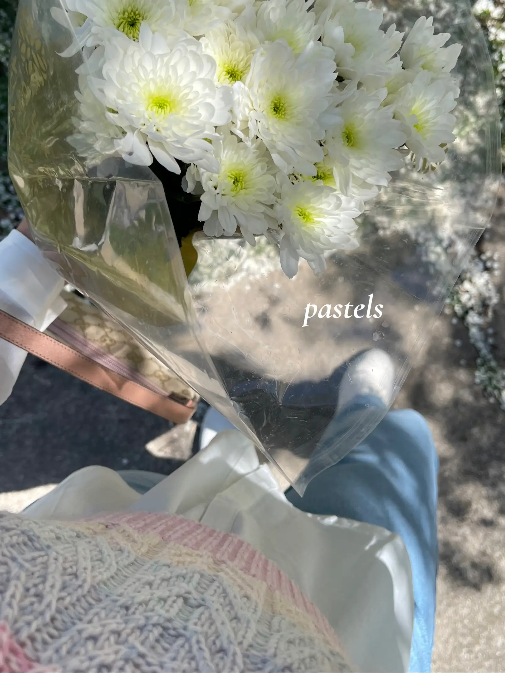  A bouquet of flowers in a vase with the words "pastels" written on the vase.