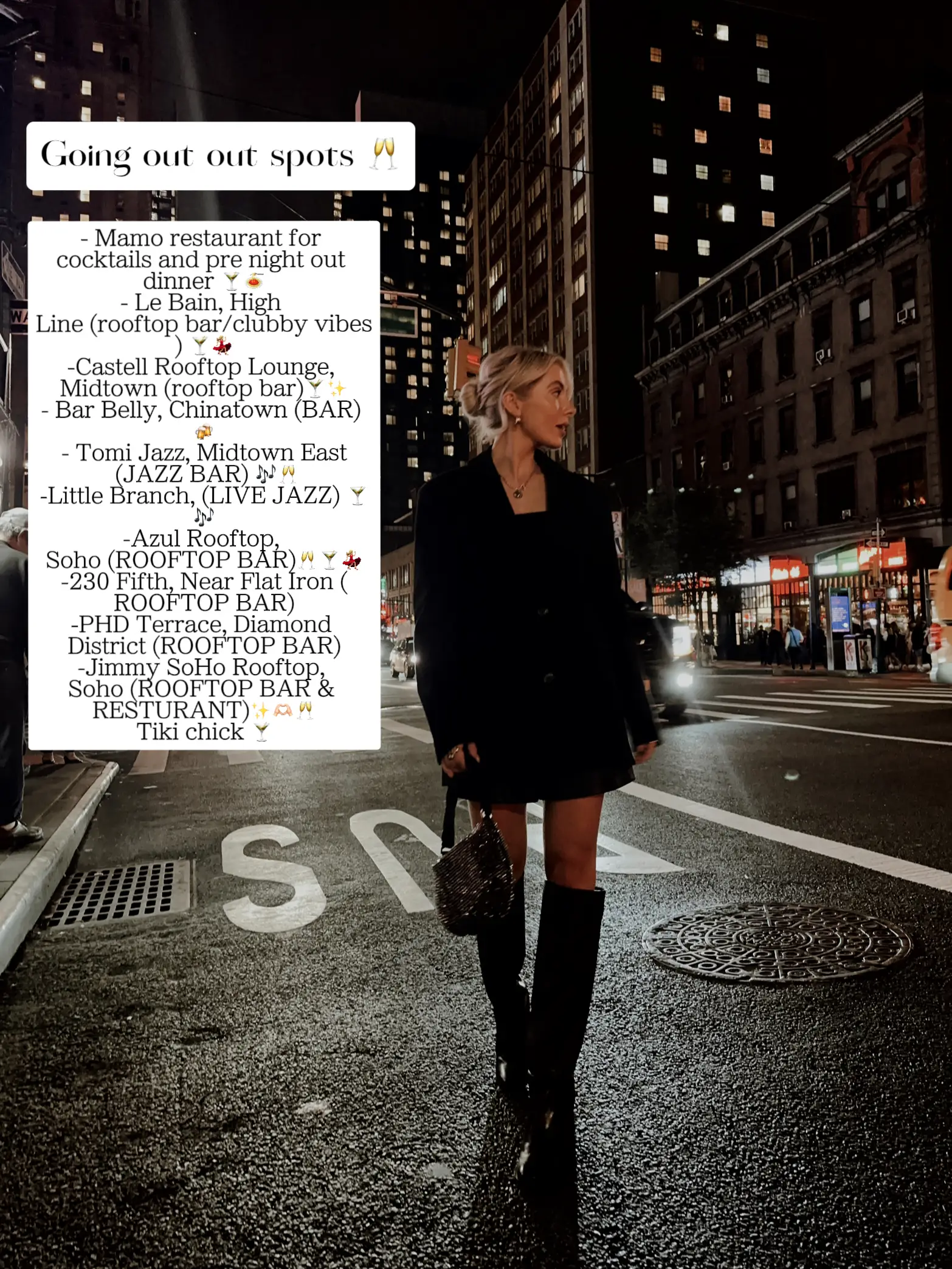  A woman is walking down a sidewalk in front of a sign that says "Going out spots". She is wearing a black jacket and is holding a purse. The sign also has a list of restaurants and bars on it.