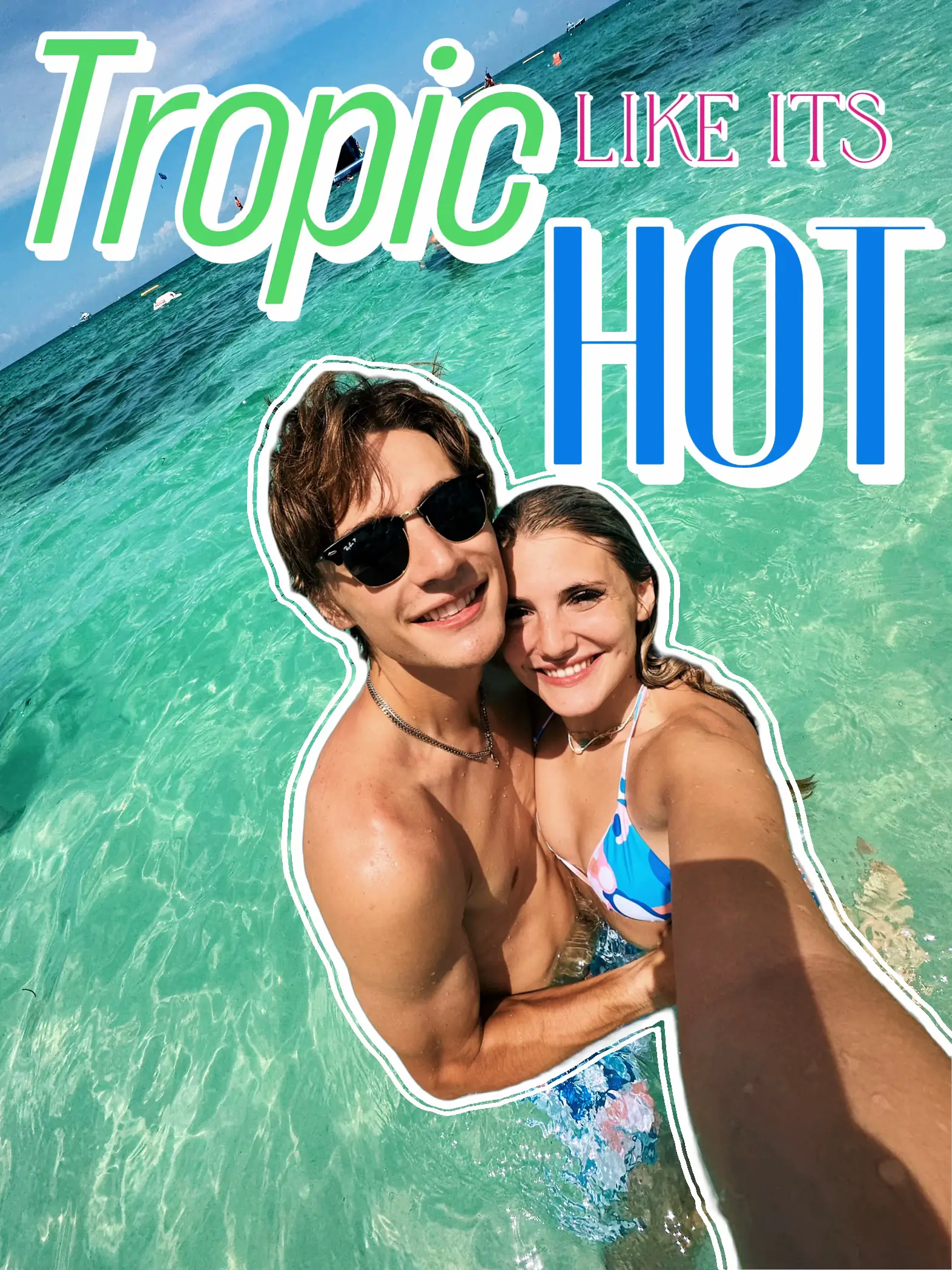  A man and a woman are standing in the water, smiling and enjoying their time. The woman is holding the man, and they are both wearing sunglasses. The man is wearing a blue swimsuit, and the woman is wearing