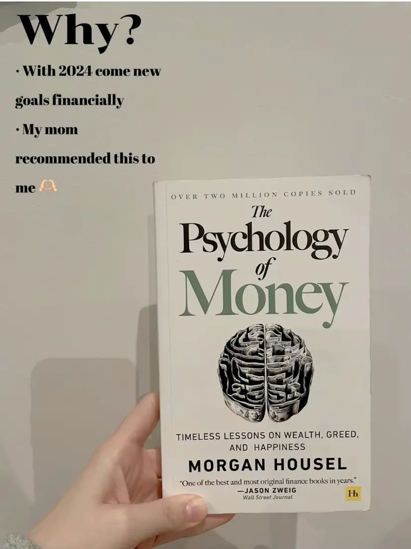  A person is holding a book titled The Psychology of Money.
