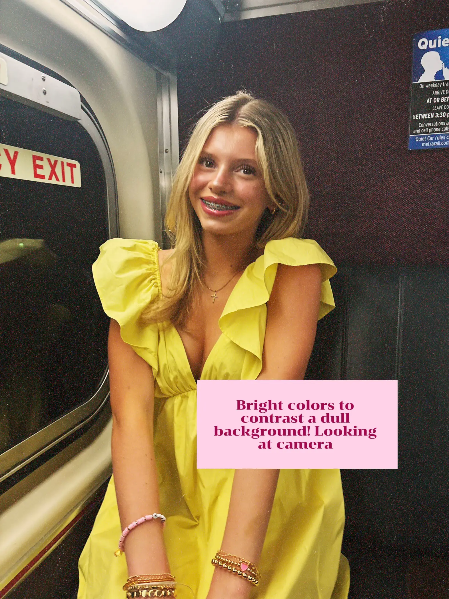  A woman in a yellow dress is sitting on a train.