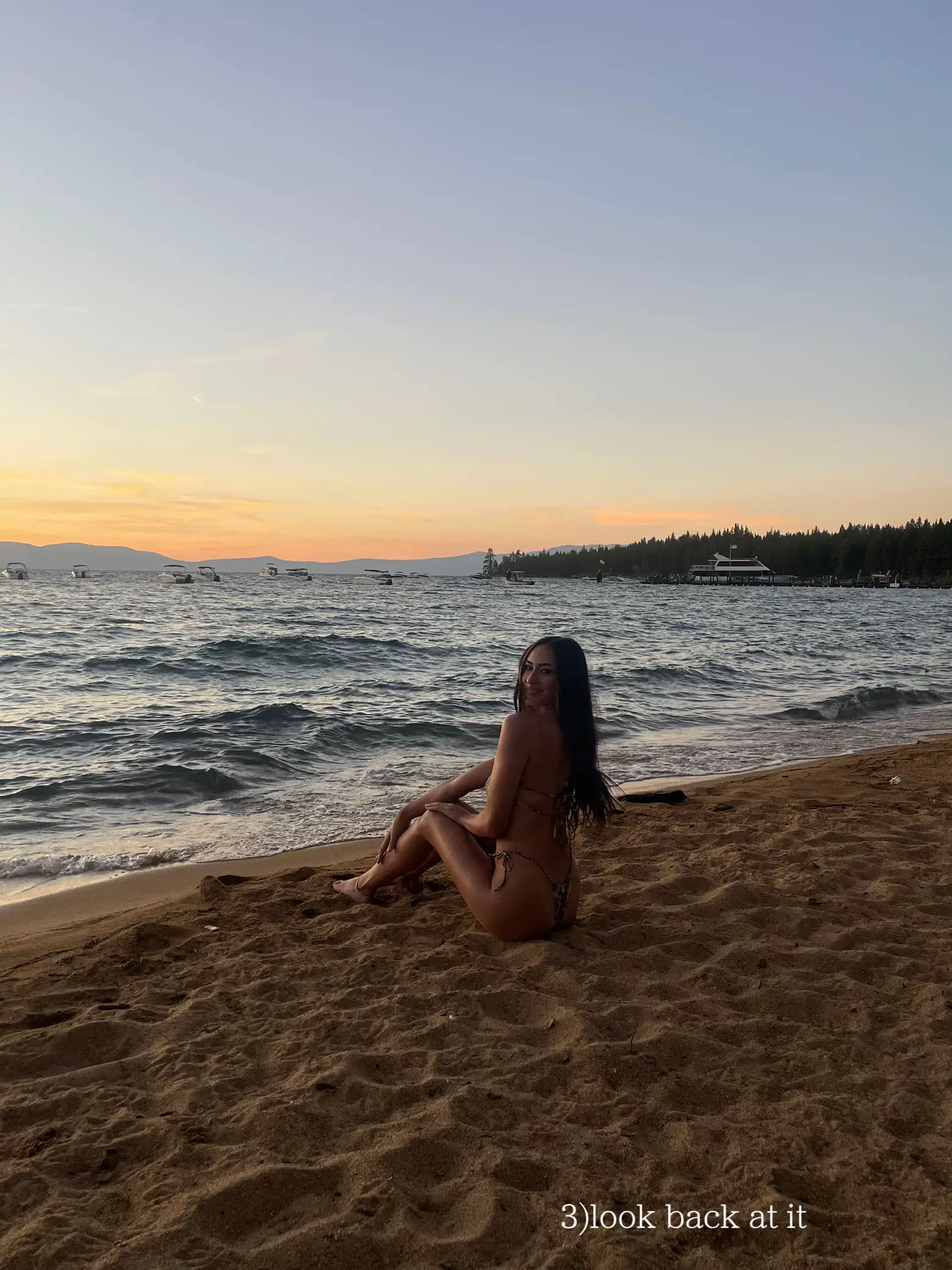  A woman in a bikini is laying on a beach.
