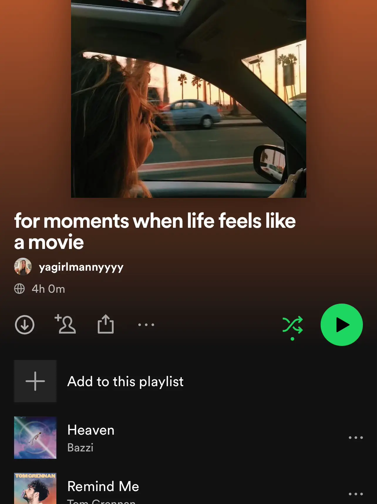  A woman is sitting in a car with a playlist of music on the screen.