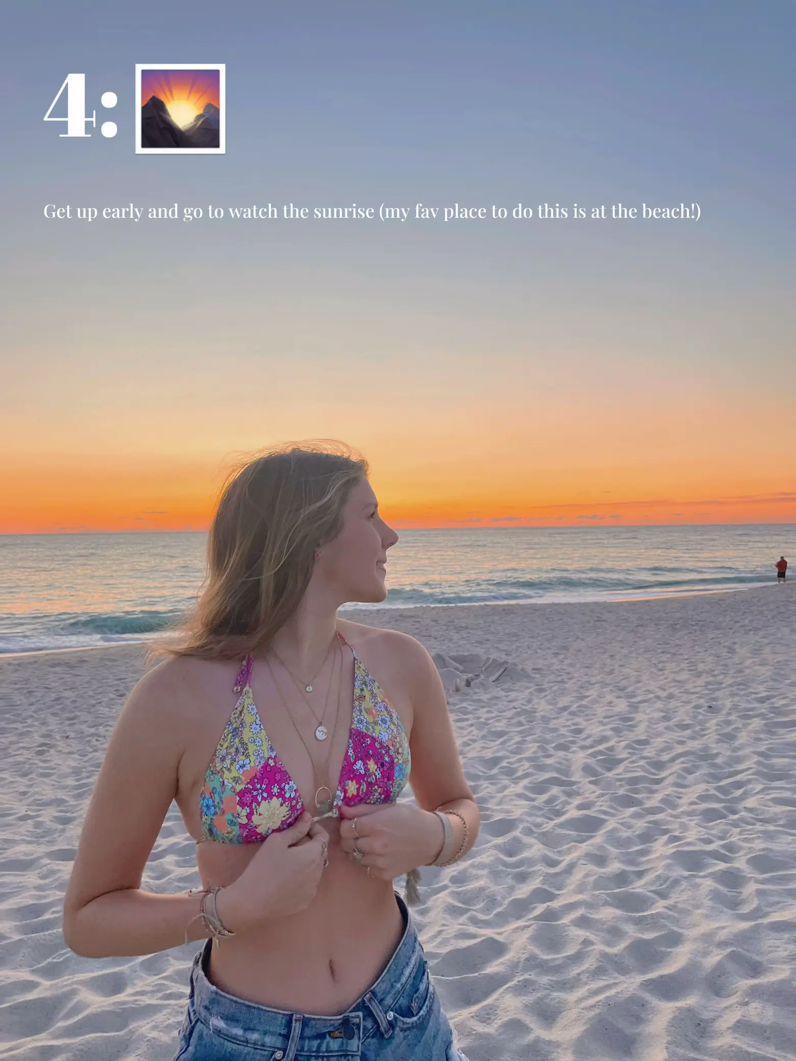  A woman in a bikini is standing on a beach, watching the sunrise.