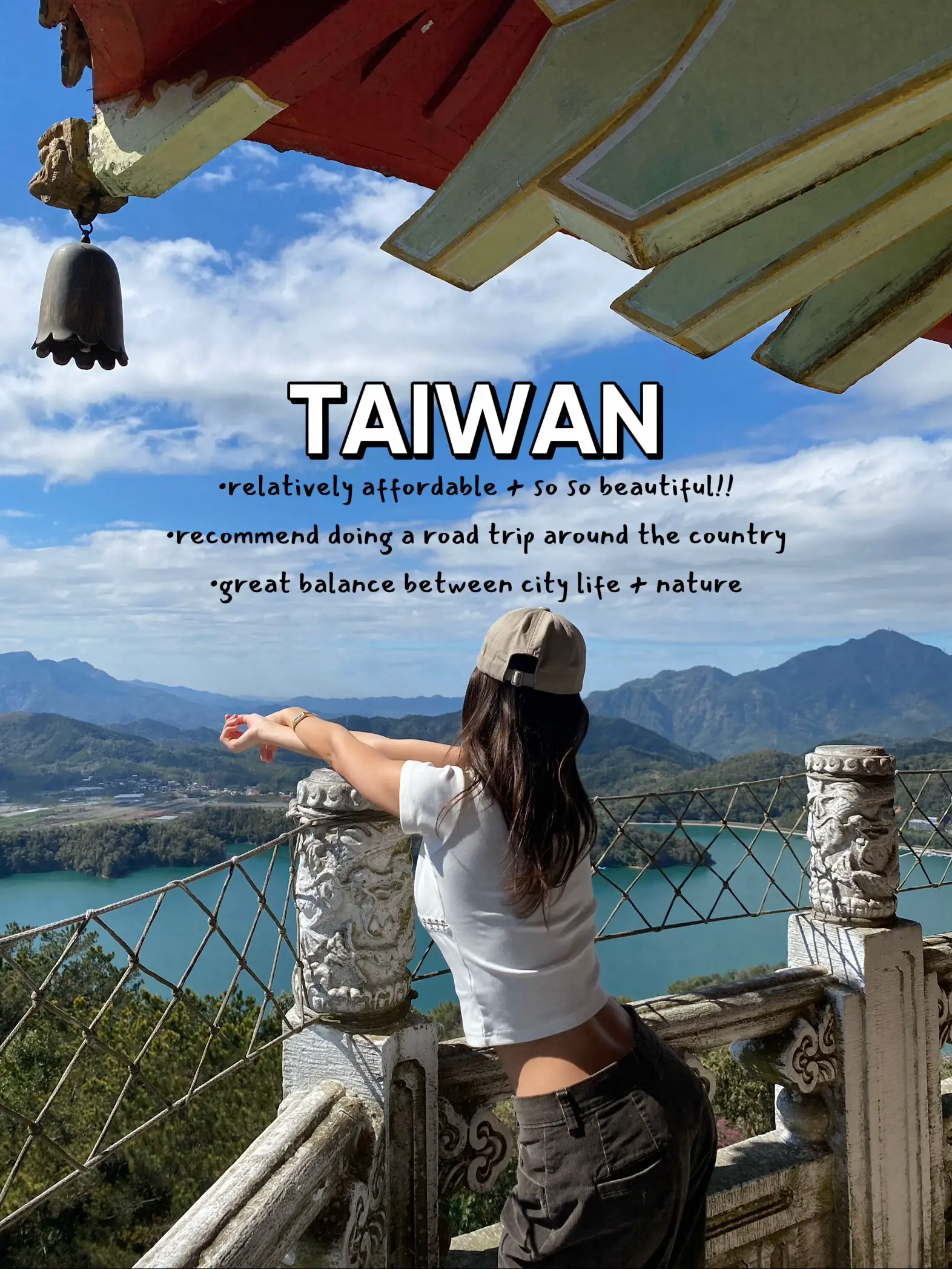  A woman is sitting on a fence overlooking a beautiful view of Taiwan.