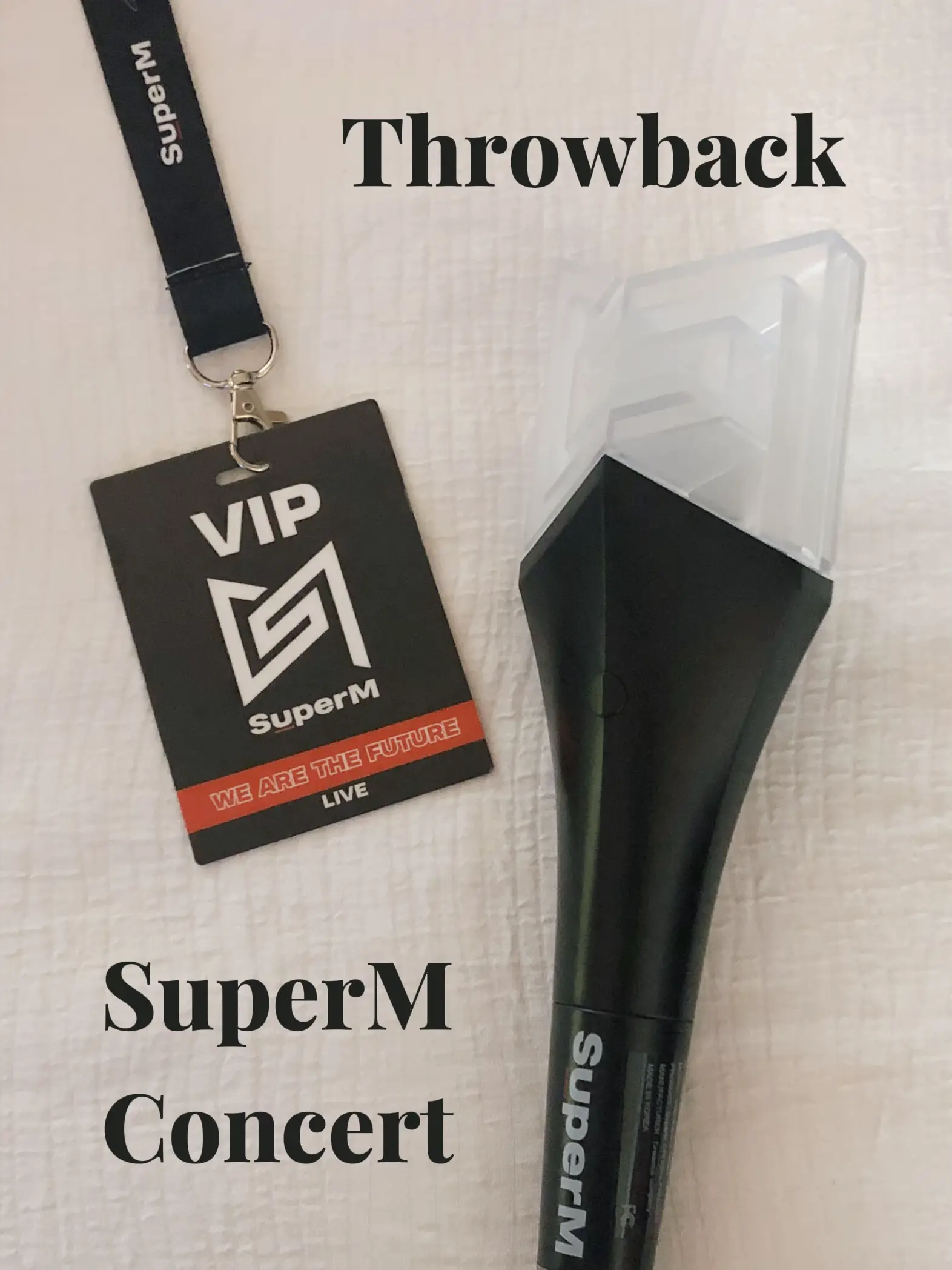  A black microphone with a white logo and the words "Super M" on it.