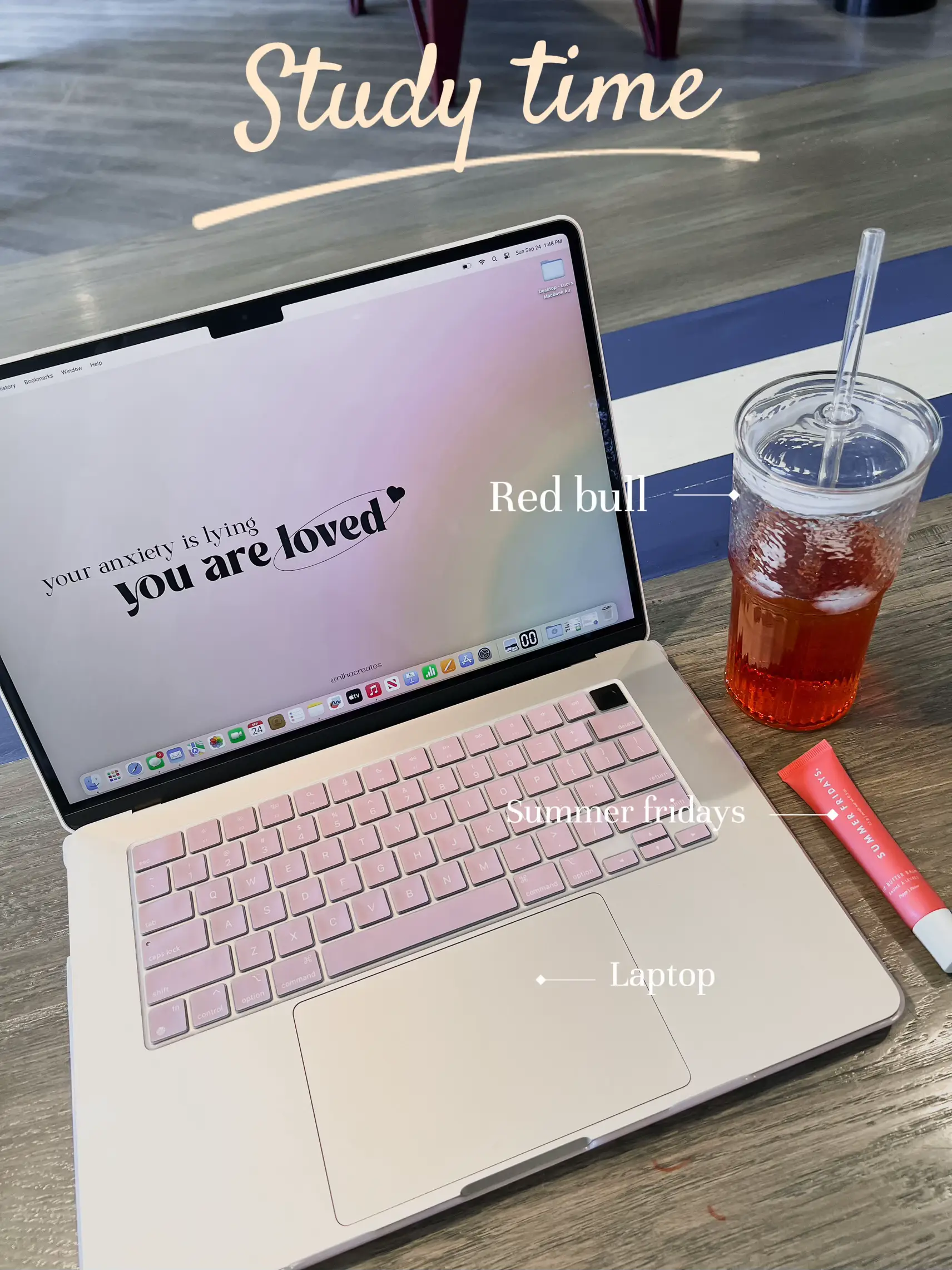  A laptop is open on a table with a cup