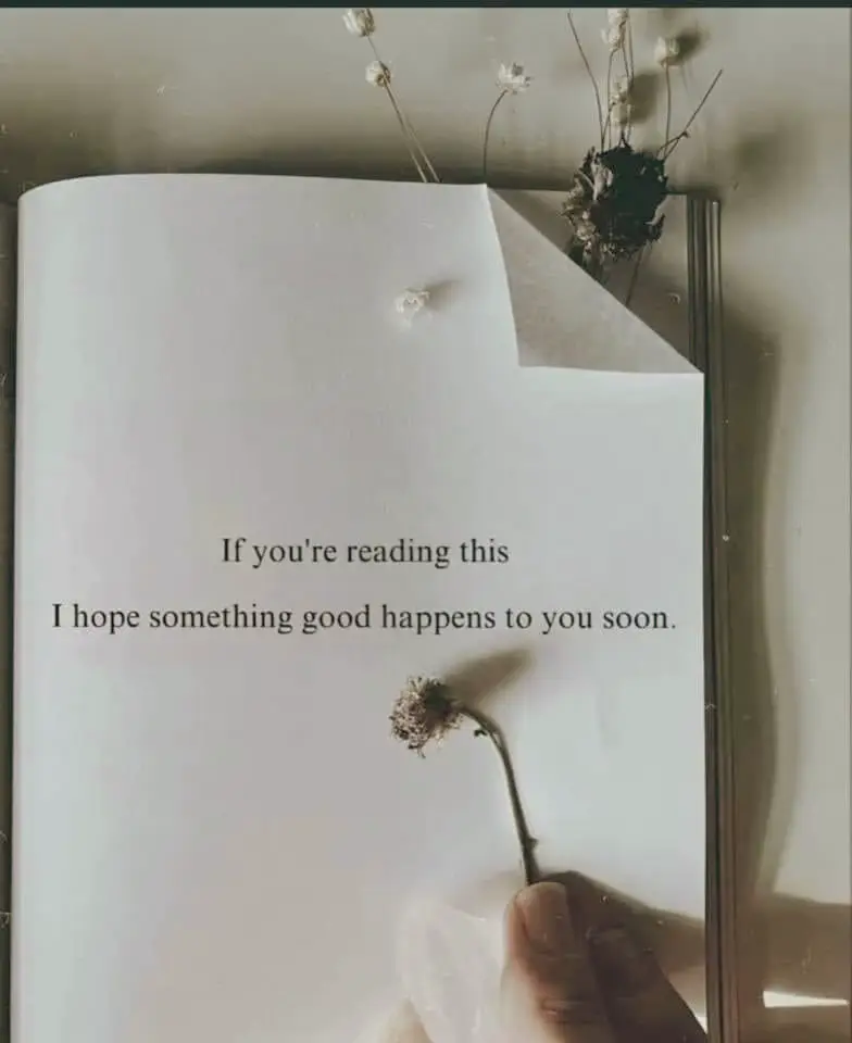  A book is open lớn a page with a handwritten note. The note says "If you're reading this I hope something good happens lớn you soon."