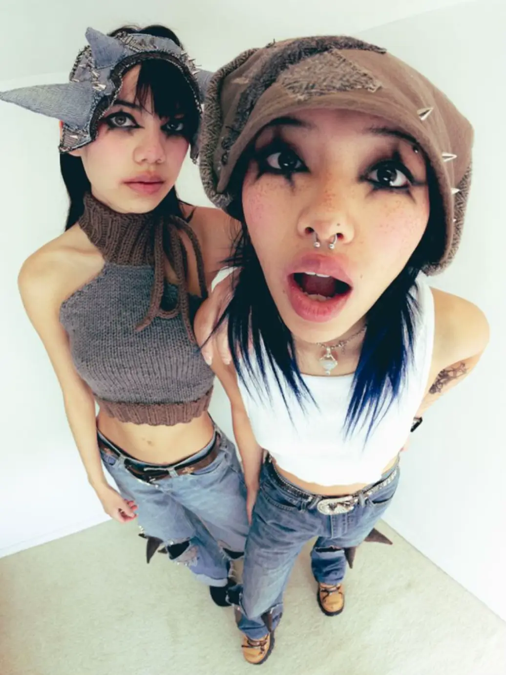  Two women wearing hats and tops.