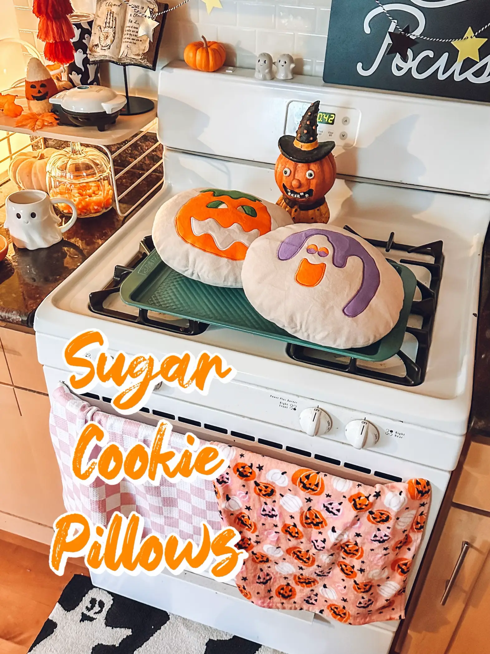  A pile of sugar cookie pillows on a stove.