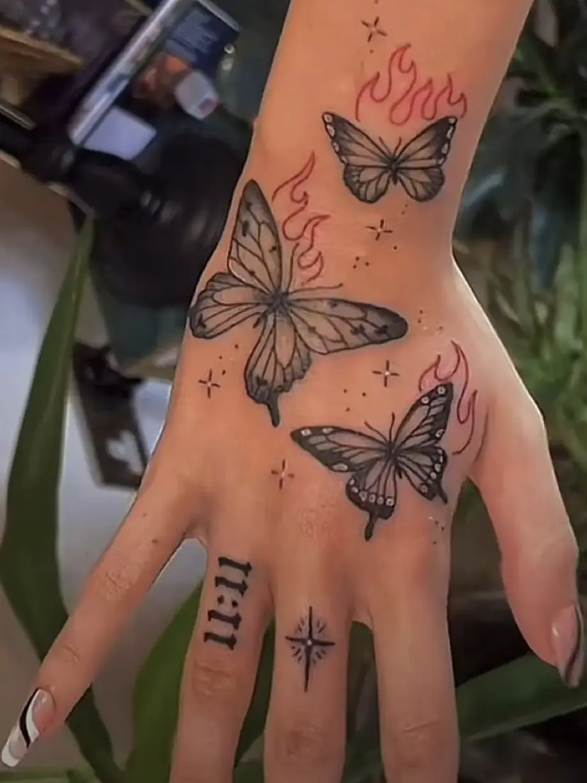 Fire Butterfly going up hand tattoo