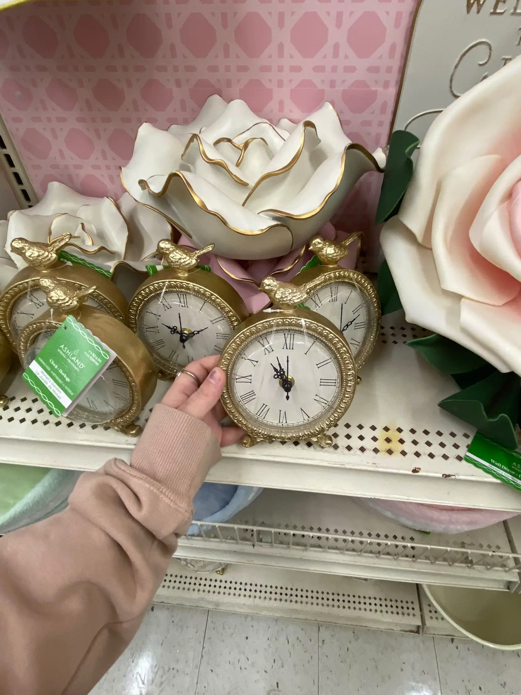  A person is holding a clock in their hand.