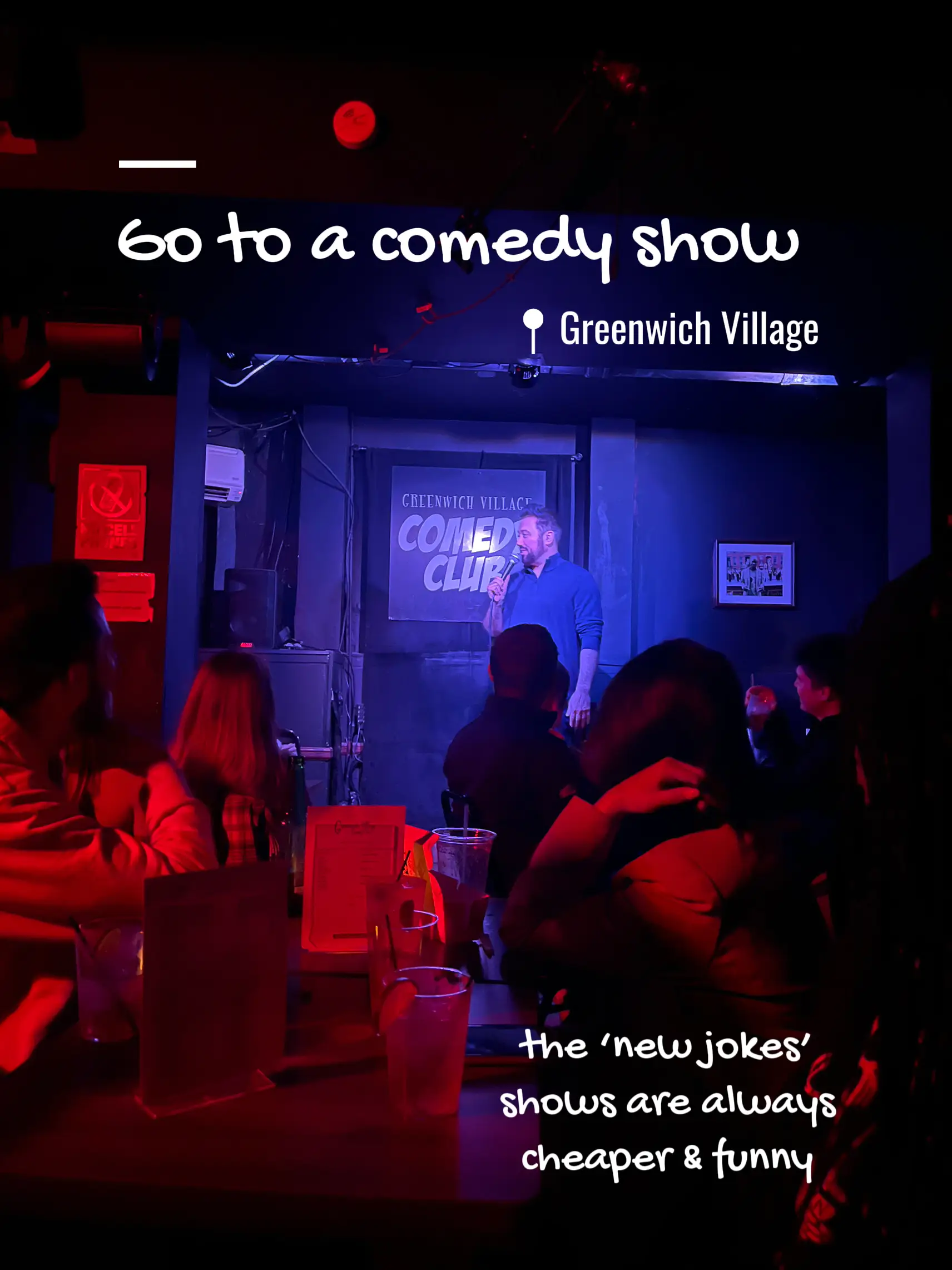 A man is standing on stage at a comedy show in Greenwich Village.